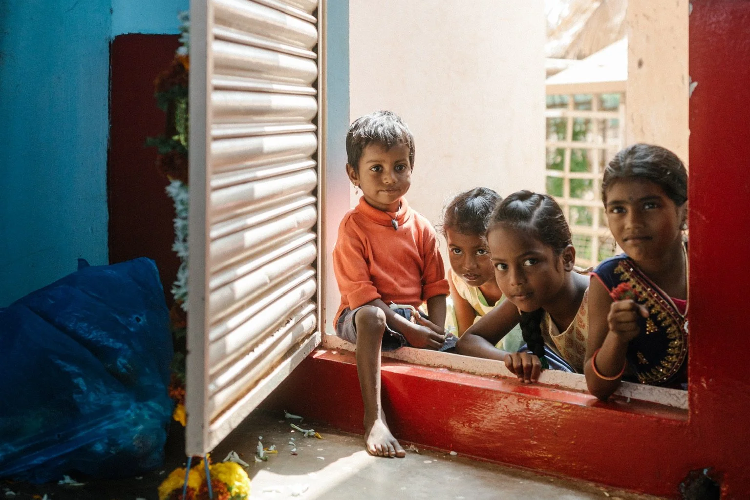 Children from India in door frame