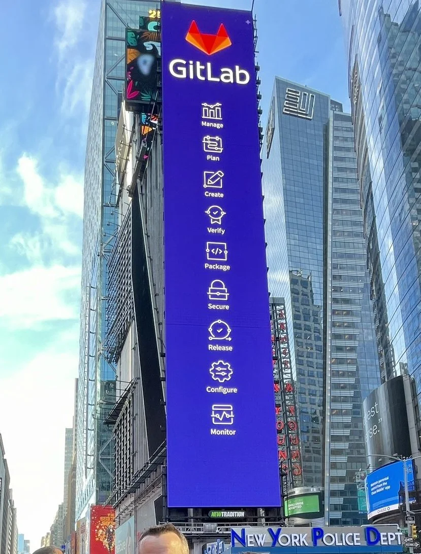 Vic Bell’s custom GitLab icons displayed on a towering digital billboard in Times Square, New York, as part of the company’s Nasdaq IPO celebrations in 2021.