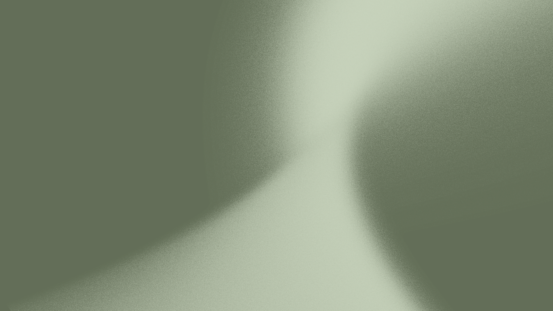 A blurry, abstract image with shades of green, light gray, and white, making it difficult to identify specific objects or scene.