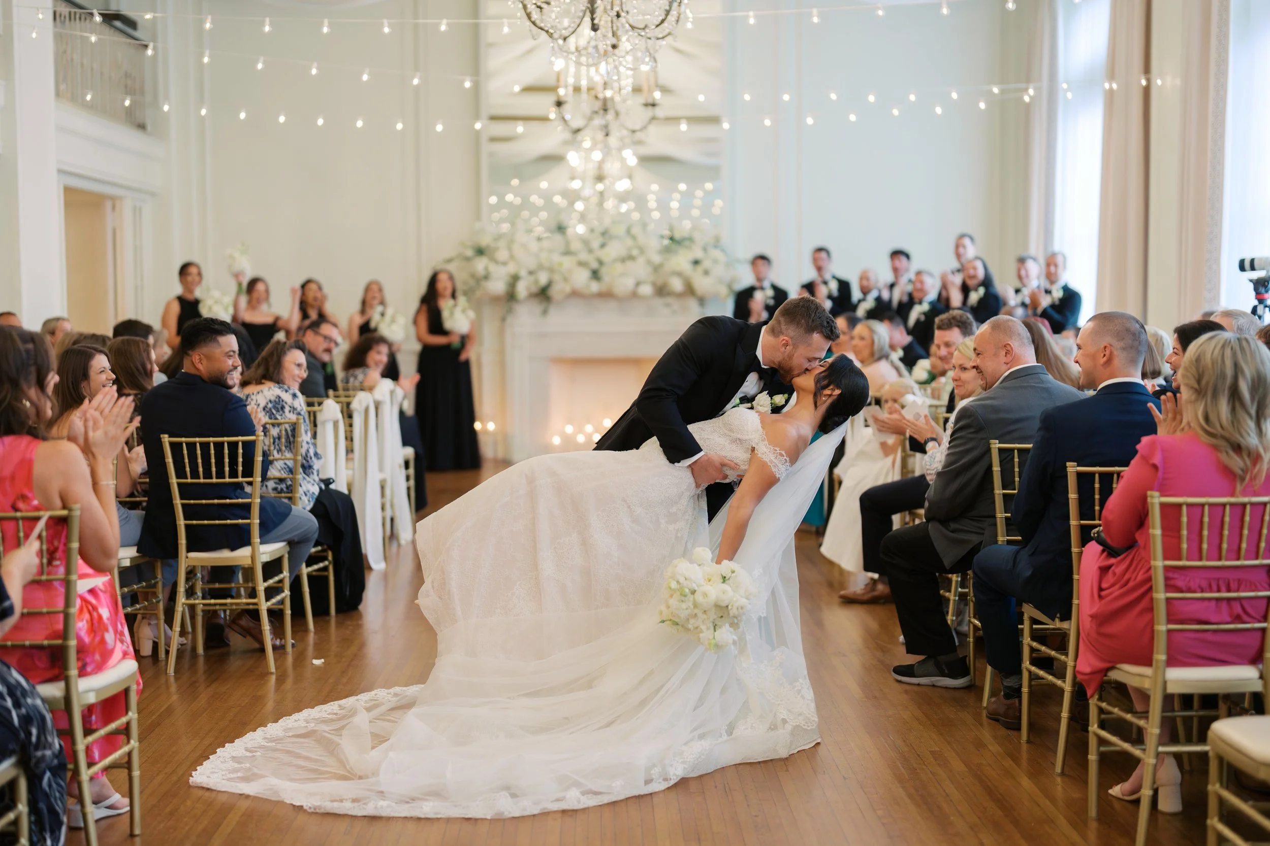 Couple poses at the end of the aisle at Hotel Concord
