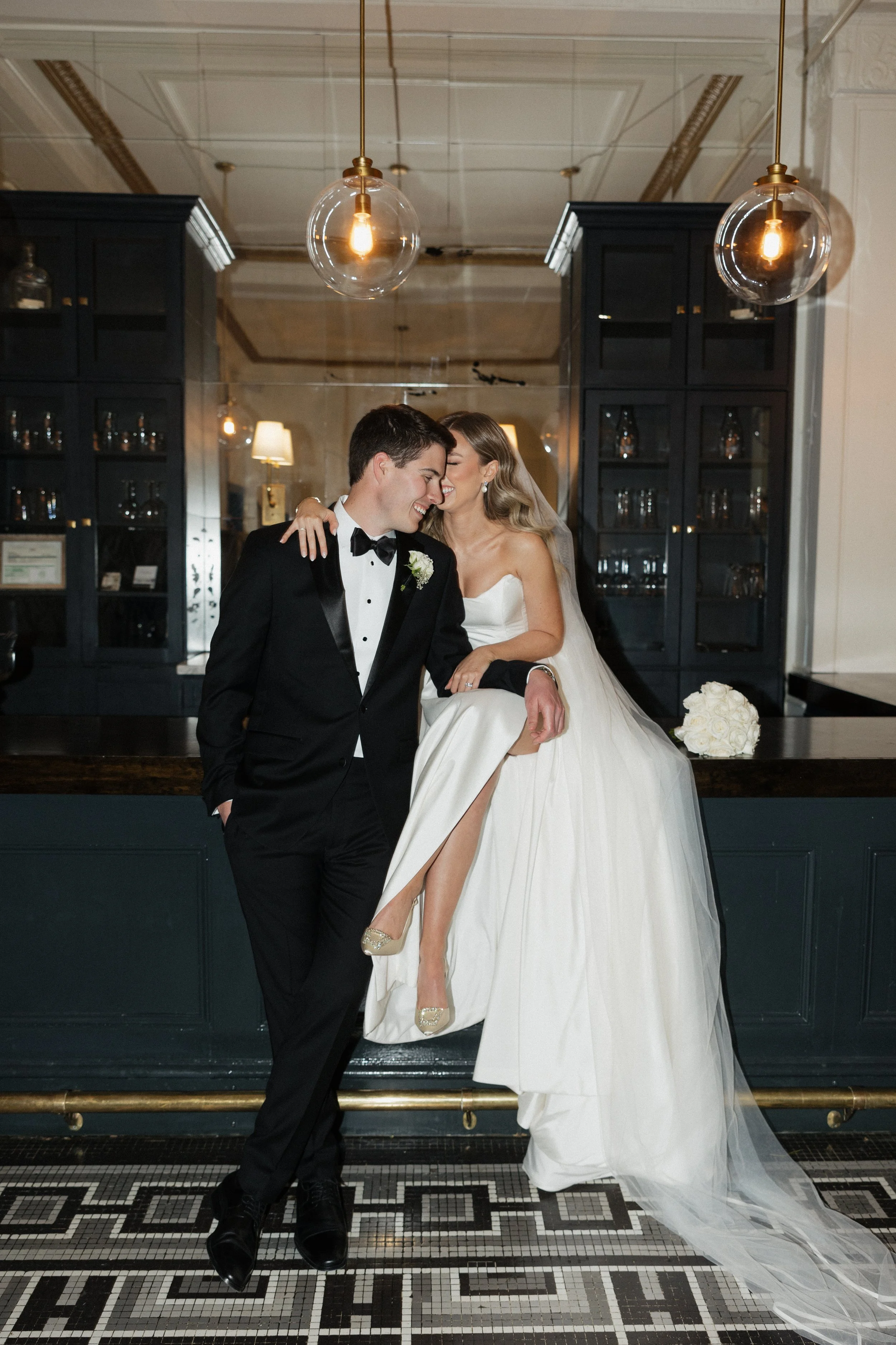 Couple sits on a bar in Charlotte area venue
