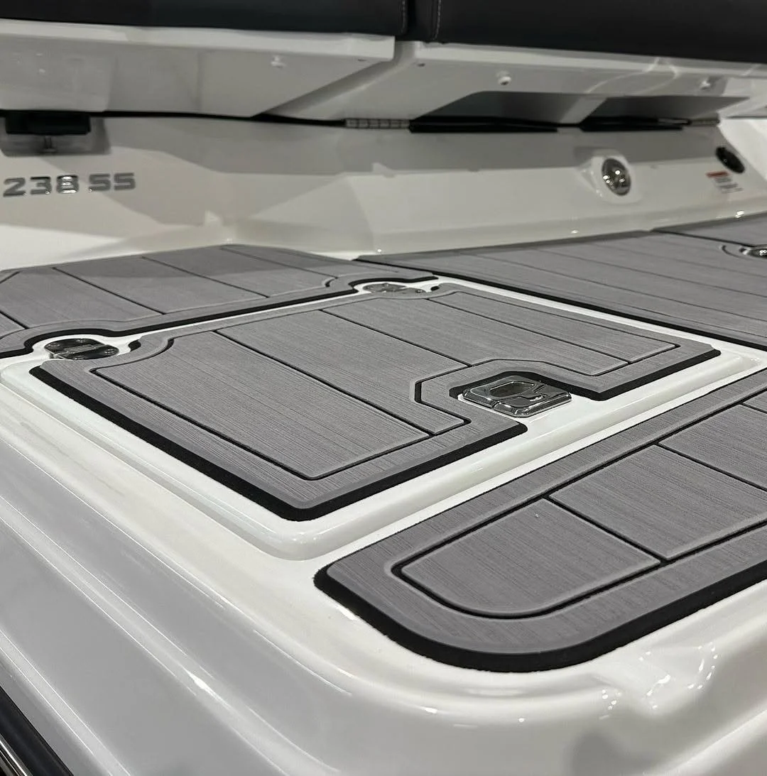 Close-up of a boat's deck with solar panels and the number 238.55 on the side.