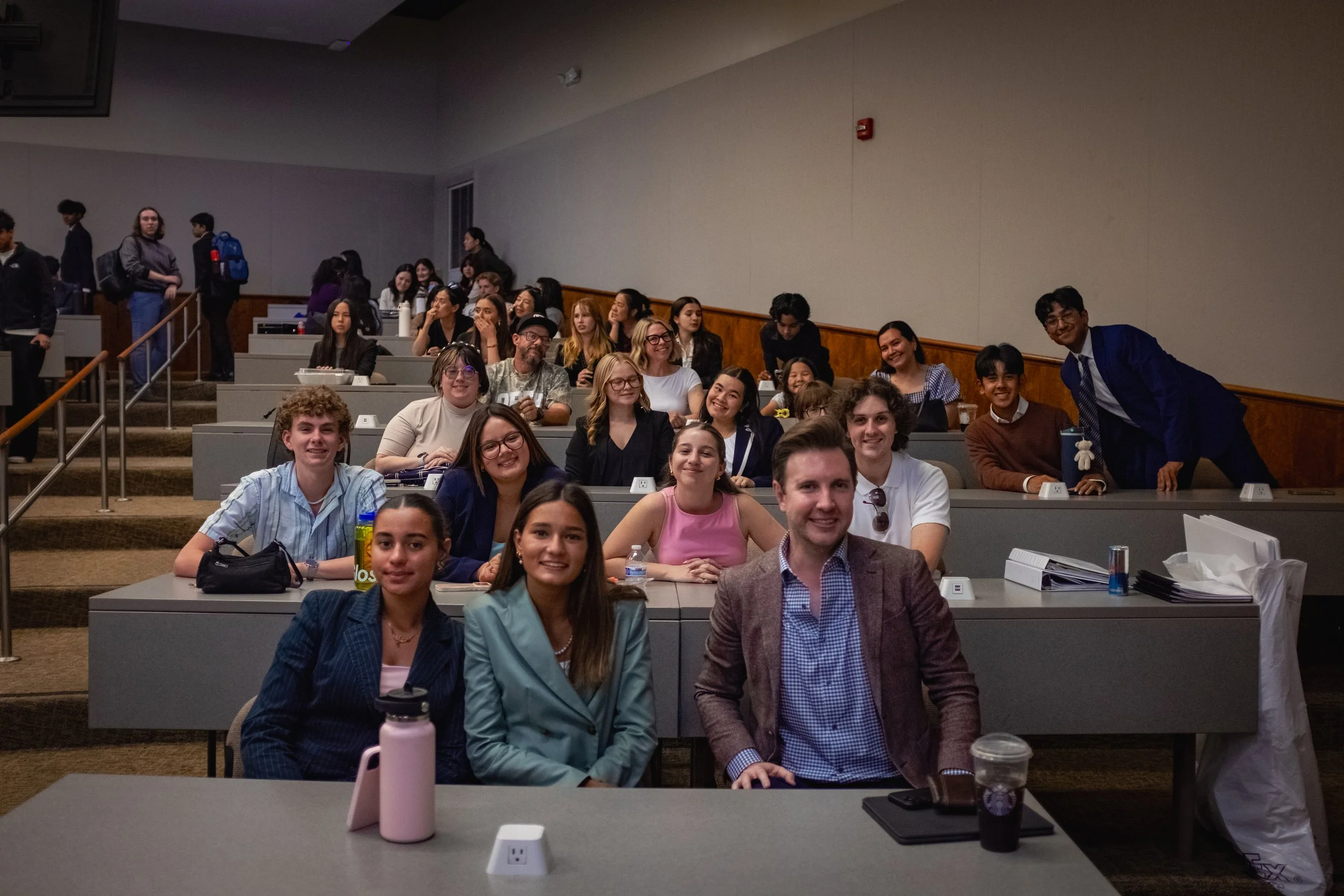 A high school mock trial teams smiles and poses together at the closing ceremony of a mock trial tournament. The Southern California Mock Trial League hosts high school mock trial tournaments across Southern California.