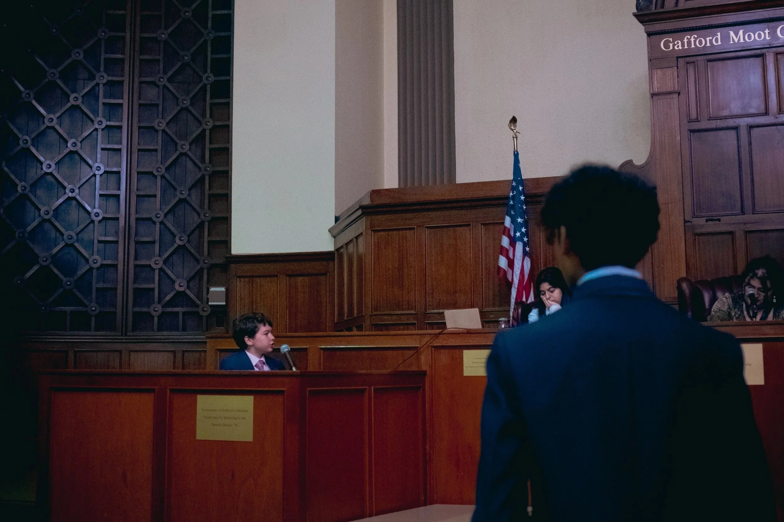 A high school mock trial tournament. A student sits at a witness stand portraying a witness while another student acts as the attorney. The Southern California Mock Trial League hosts high school mock trial tournaments across Southern California.