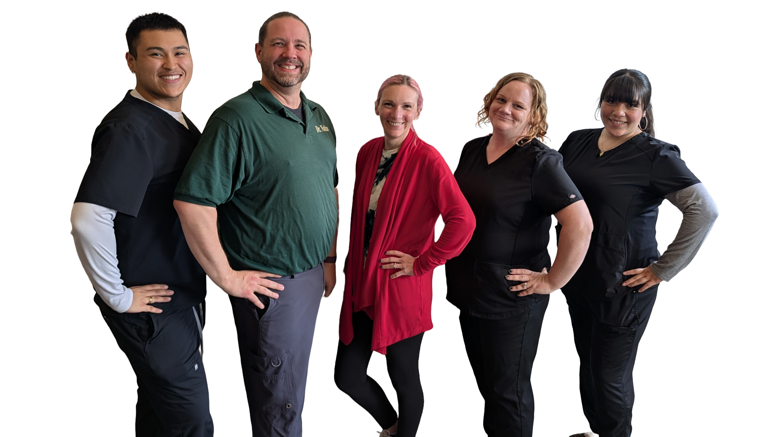 Group of five healthcare professionals standing together, smiling, in medical scrubs and casual attire.