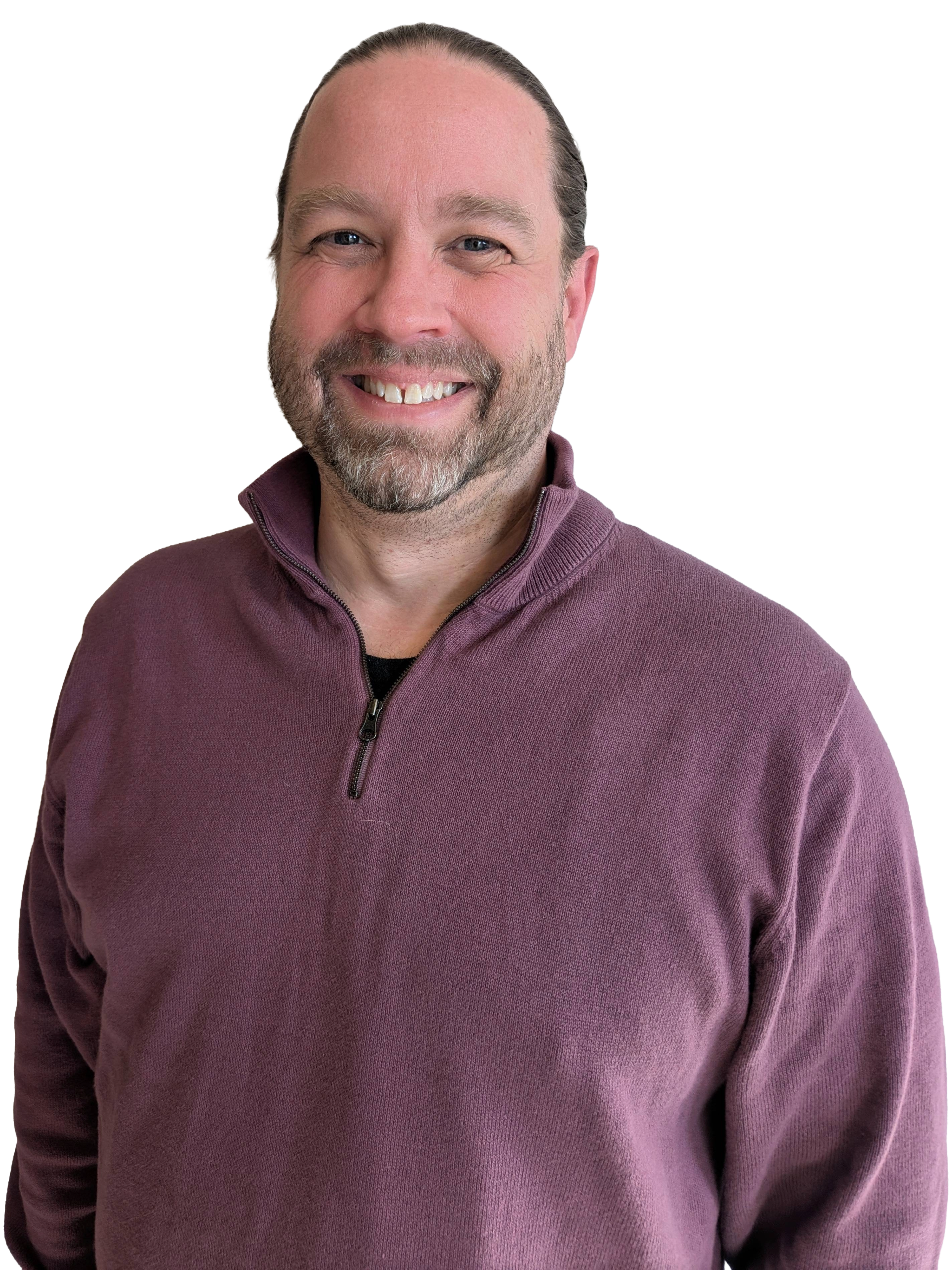 A smiling man with a beard and mustache wearing a purple zip-up sweater.