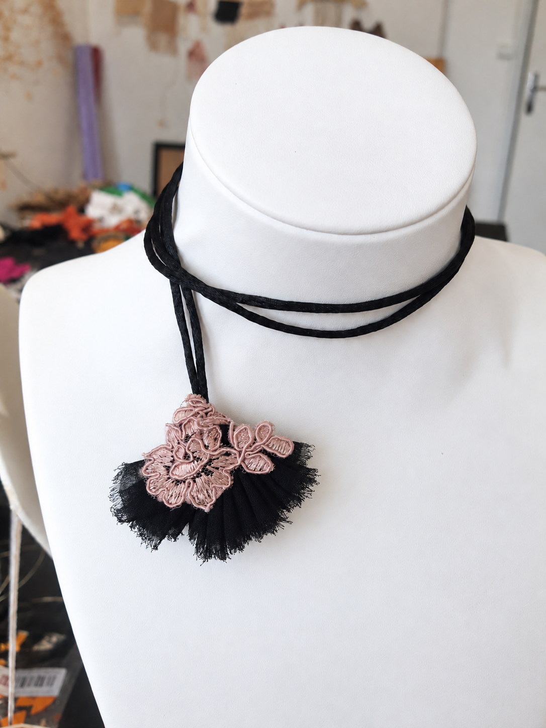 Pendentif floral noir et rose sur buste.png