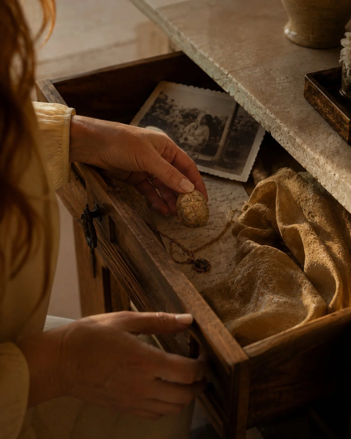 Woman rediscovering meaningful personal keepsakes as a reflection on identity and remembrance.