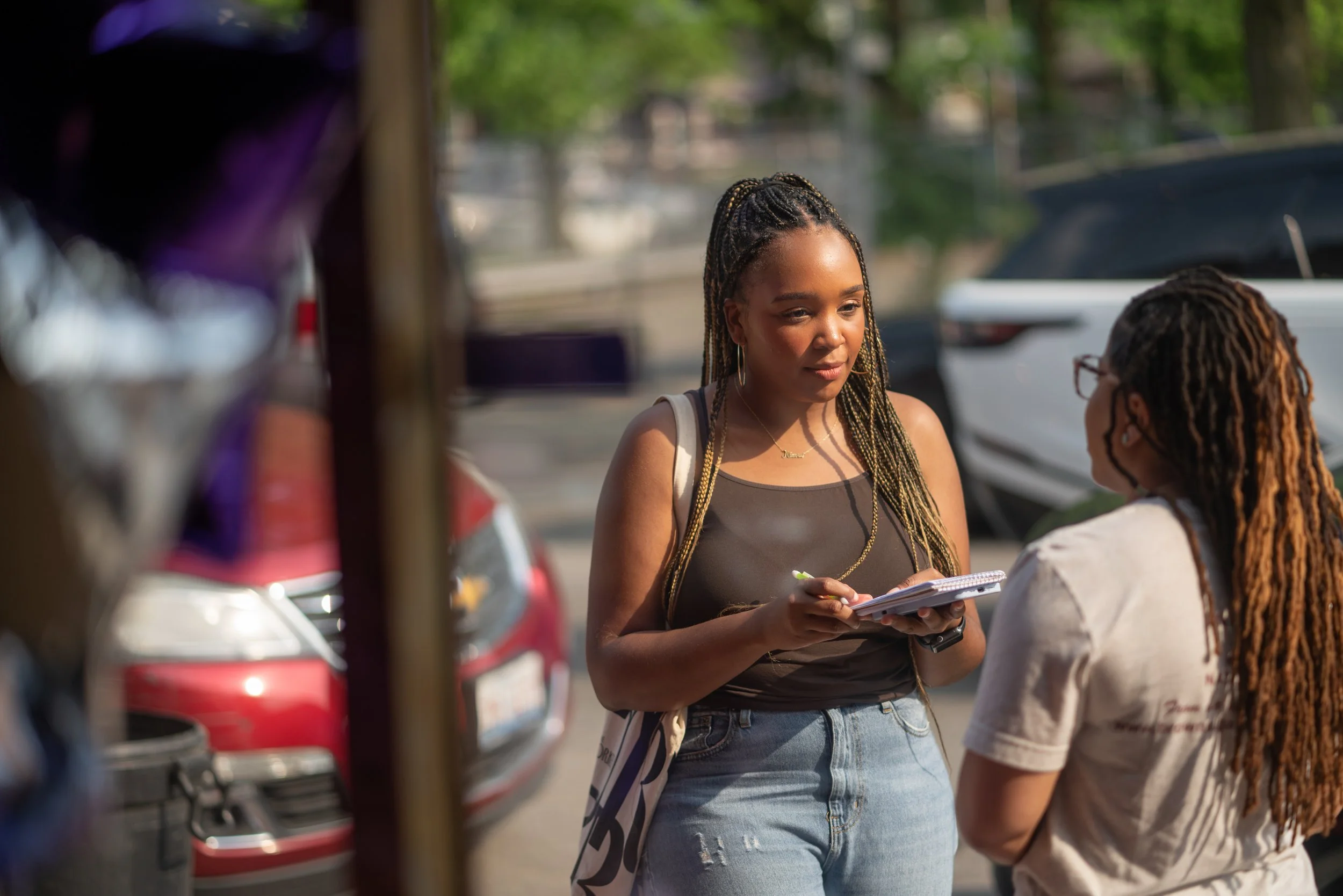 Reporter Atavia Reed interviews person on street.