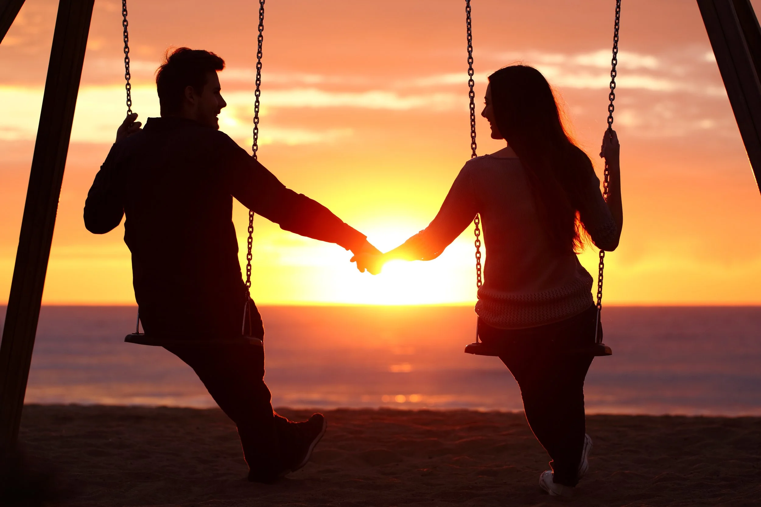 Socialized couple on swings