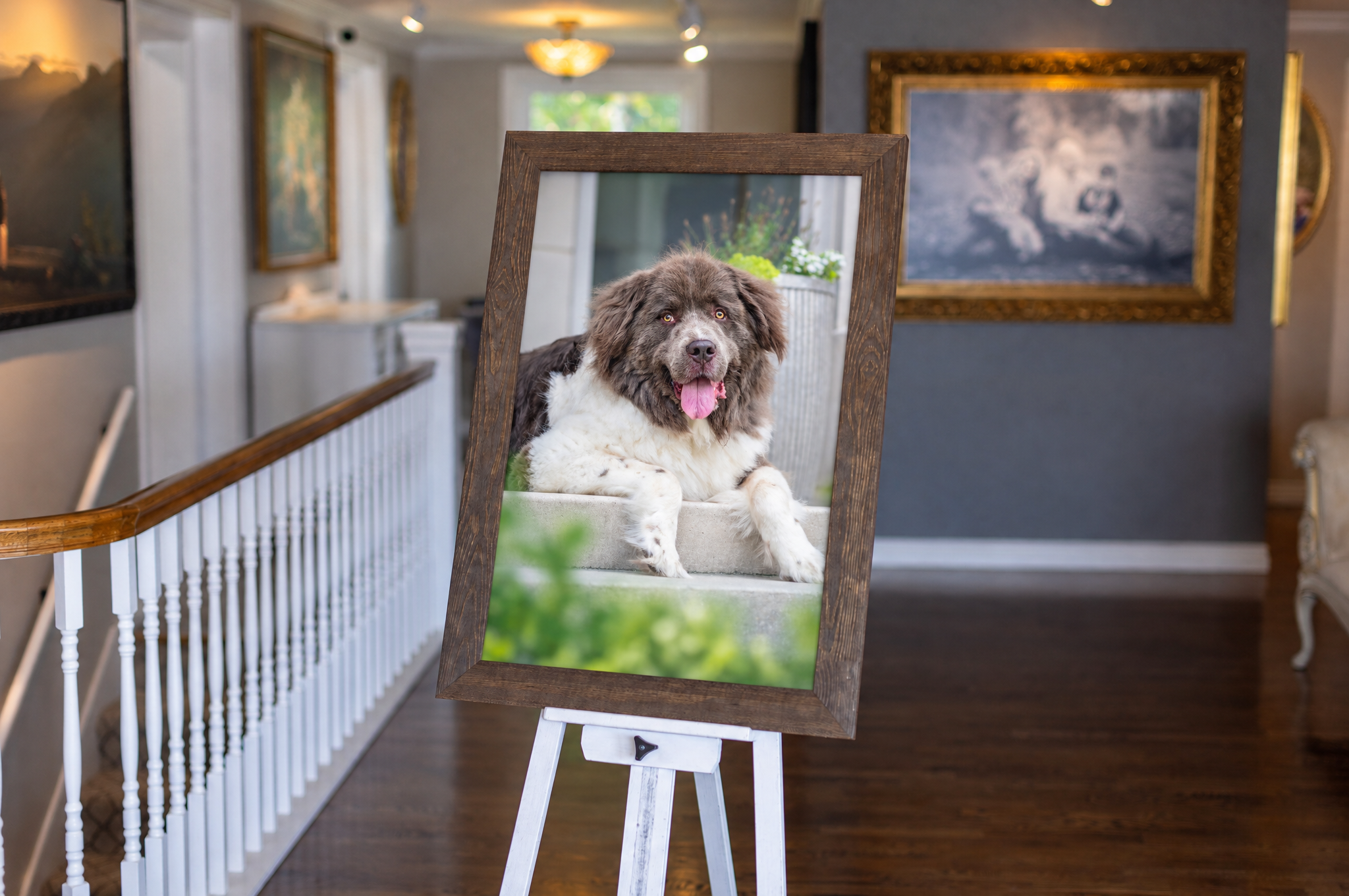 Framed portrait of a happy brown and white dog displayed on an easel in an elegant home hallway