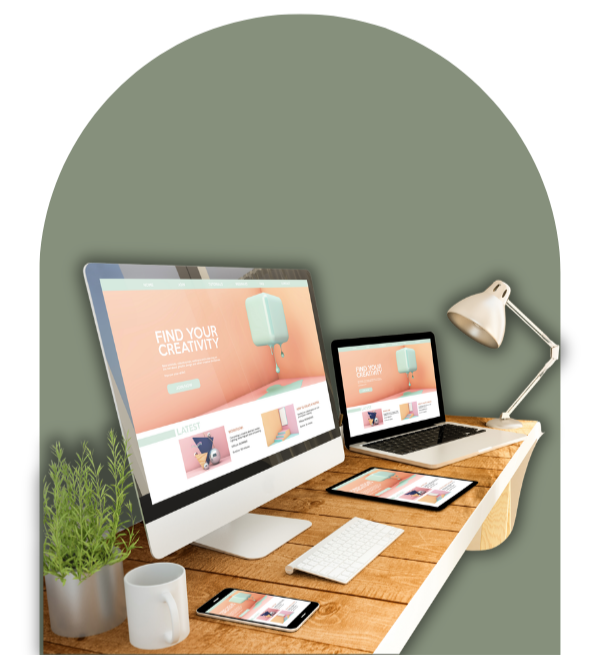 Desktop workspace with iMac, MacBook, iPad, iPhone, desk lamp, potted plant, and coffee mug on wooden desk.