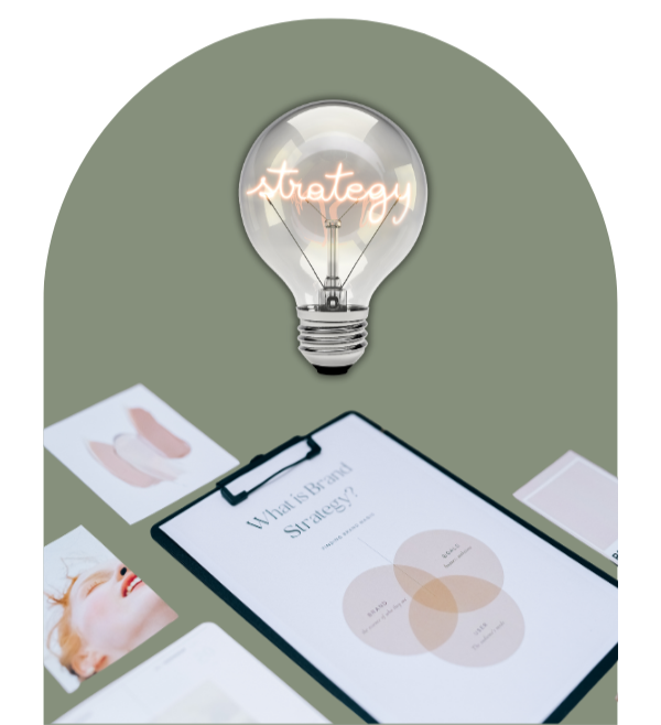 A light bulb with the word "strategy" inside, surrounded by various documents and charts on a table.