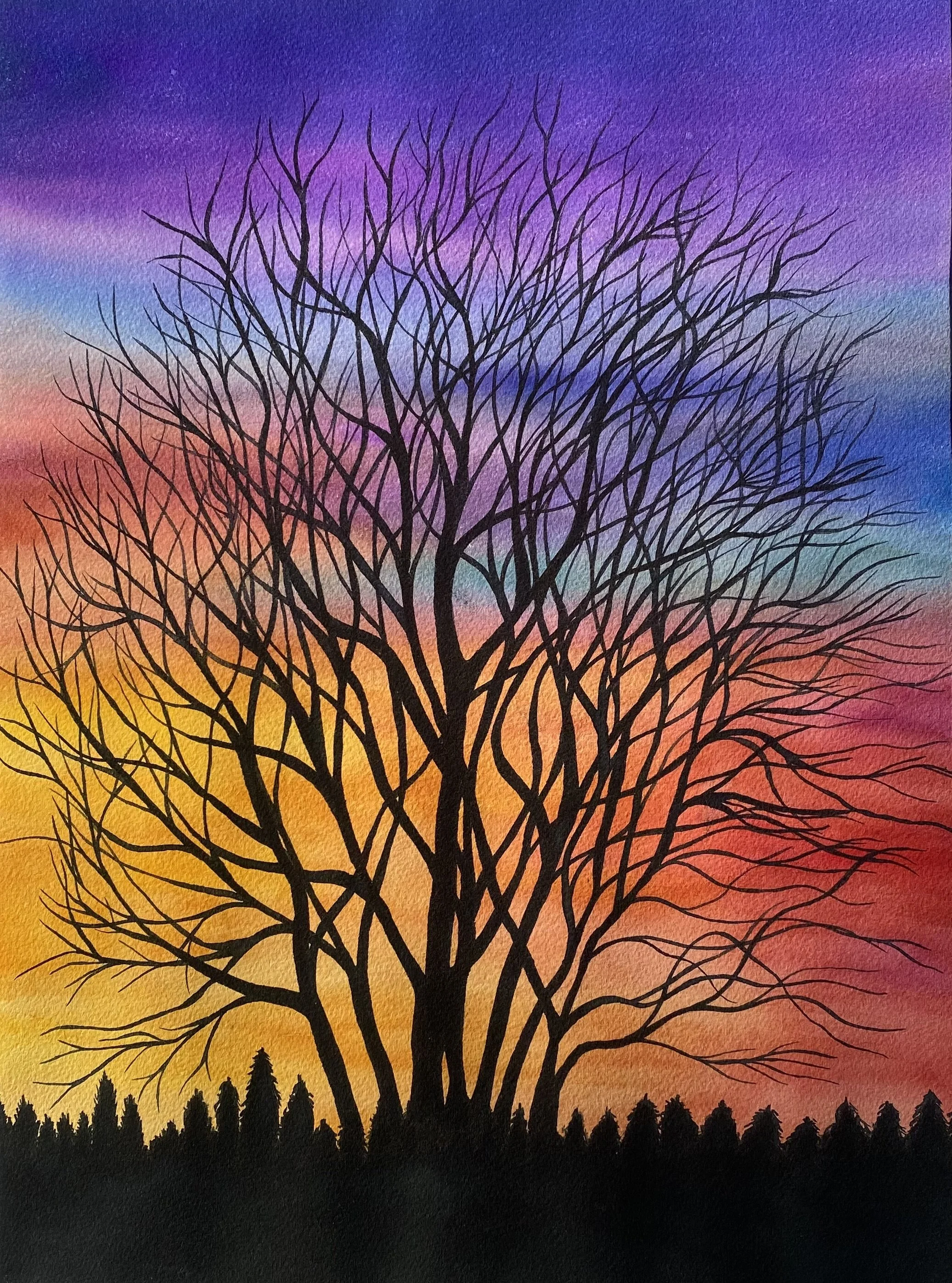 Silhouette of a large leafless tree against a colorful sunset sky with shades of purple, pink, orange, and yellow, and a row of smaller trees at the bottom.