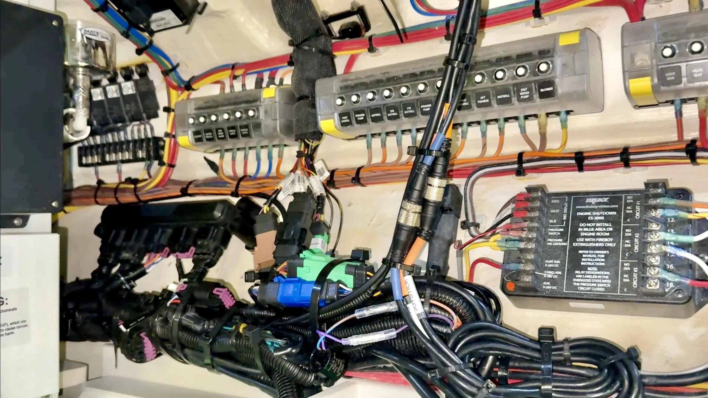 Electrical control panel with various wires, switches, and a circuit breaker.