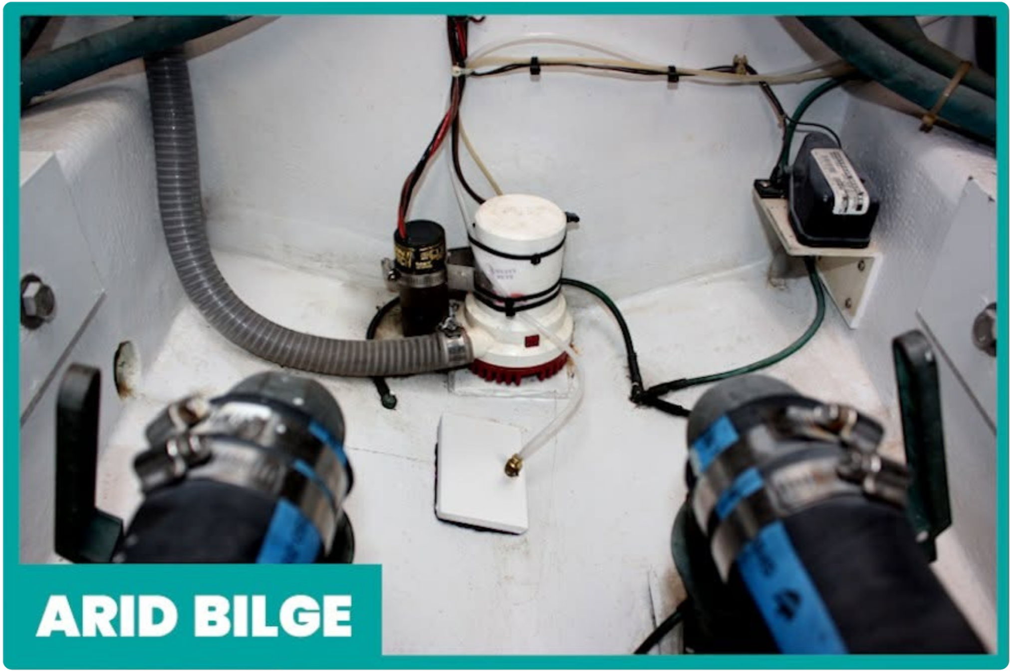 View of mechanical parts, hoses, wires, and equipment in an indoor setting, likely inside a boat or engine room.