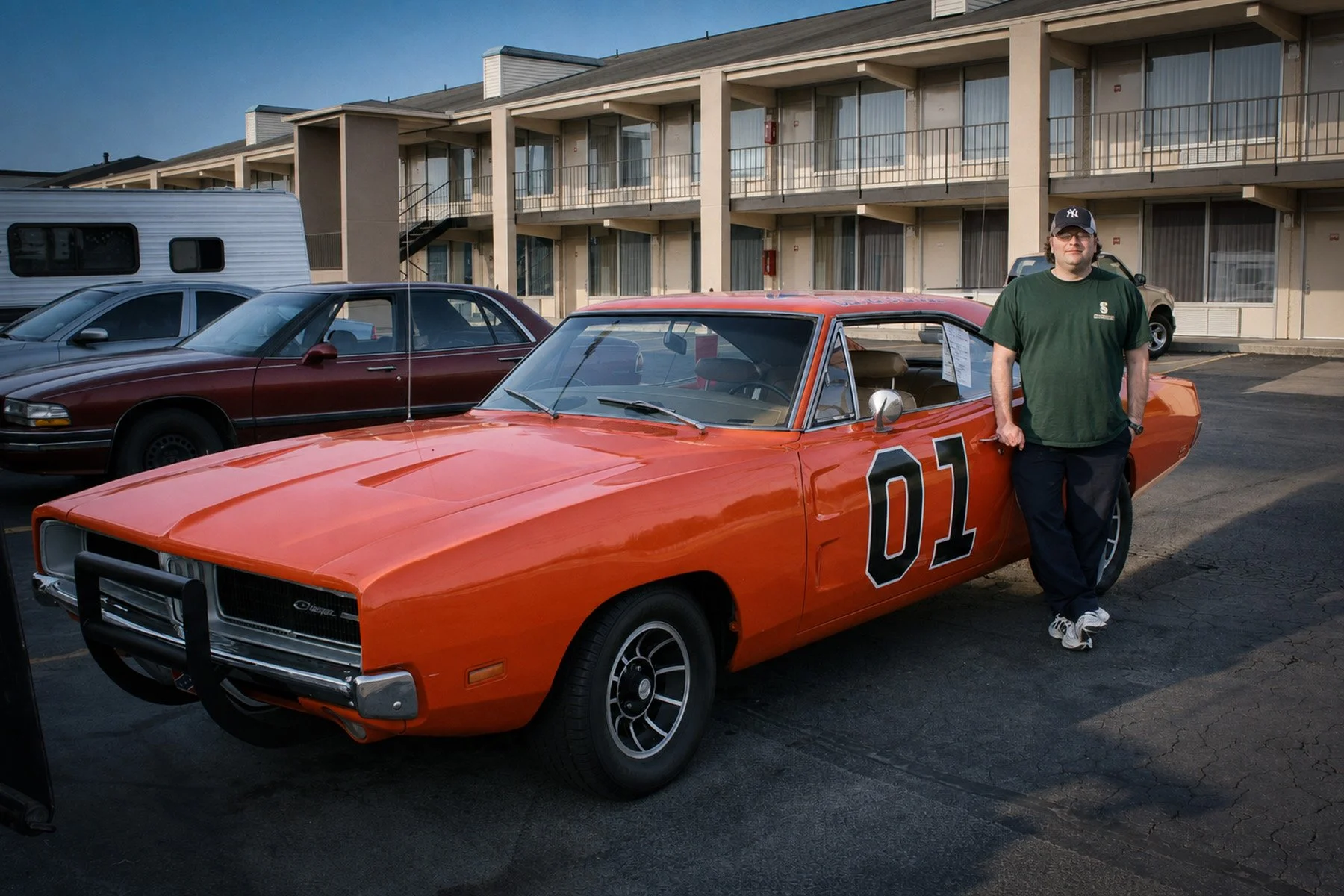 Tim San Fillippo standing beside an orange General Lee Dodge Charger outside Cooter’s Place in Nashville.