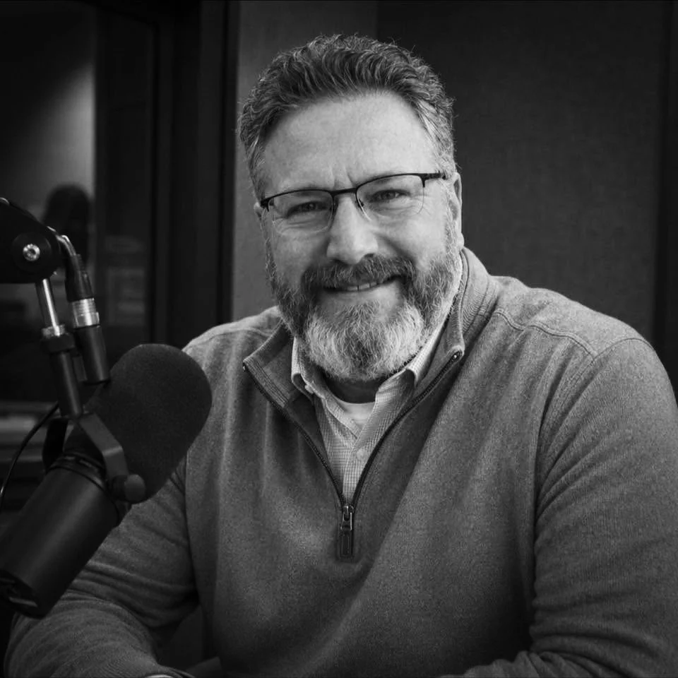 Tim San Fillippo, founder and Editor-in-Chief of POP nakaro, photographed in his recording studio surrounded by microphones and pop culture memorabilia.
