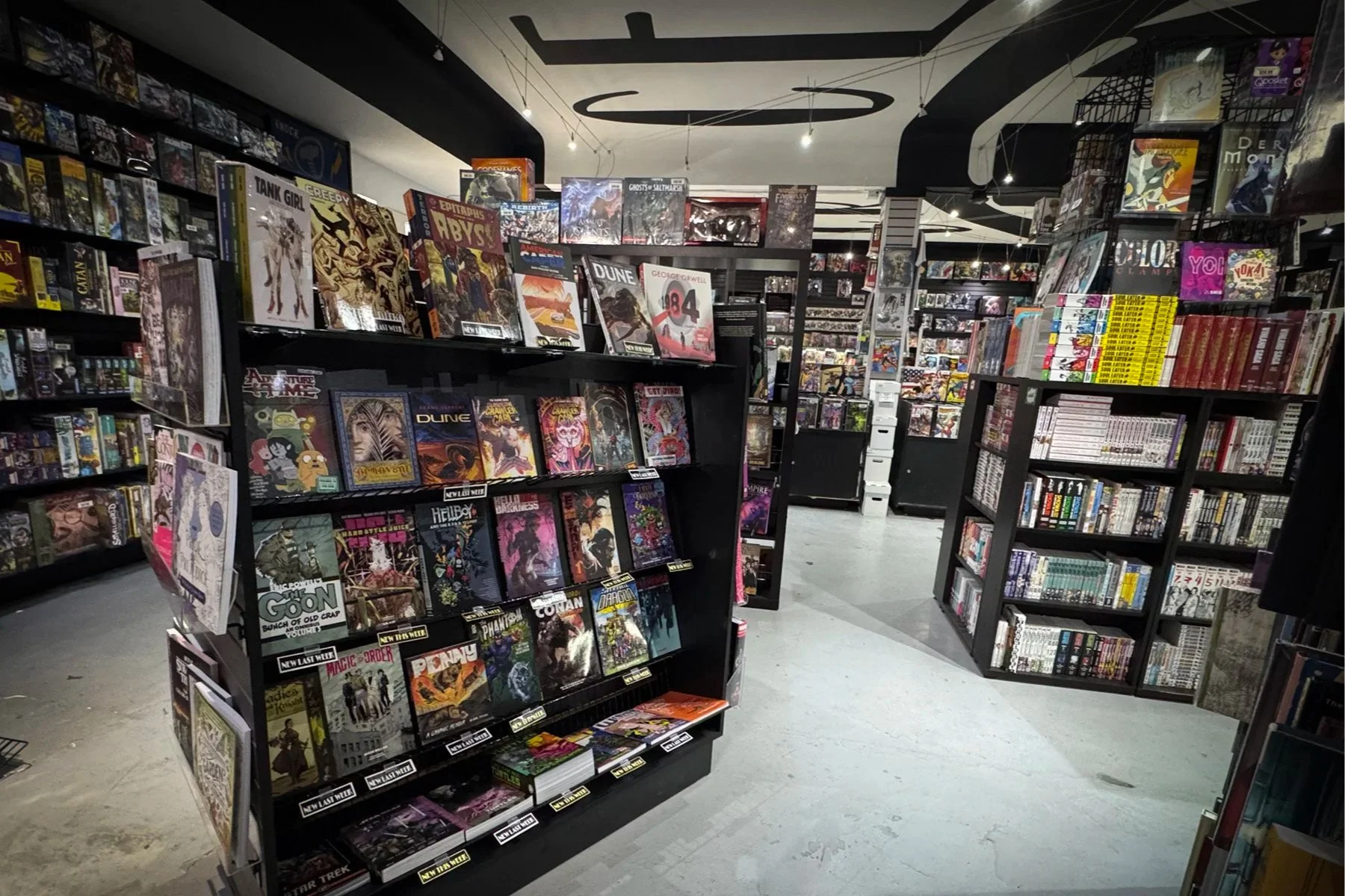 Graphic novels, manga and comics displayed throughout the interior of Crescent City Comics on Calhoun Street.