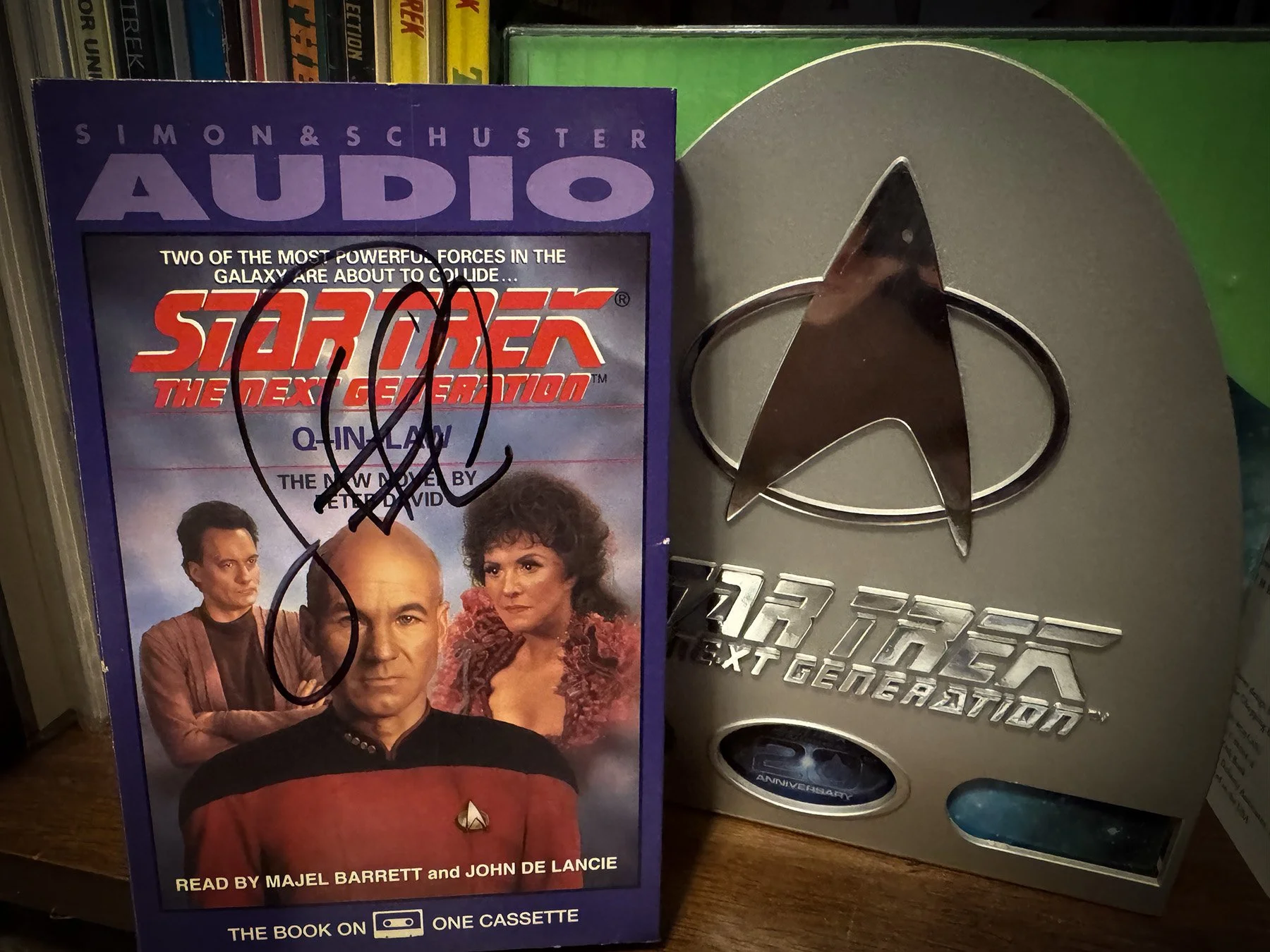 Signed Star Trek: The Next Generation: Q-in-Law audiobook by John de Lancie displayed beside the complete Star Trek: The Next Generation DVD box set.