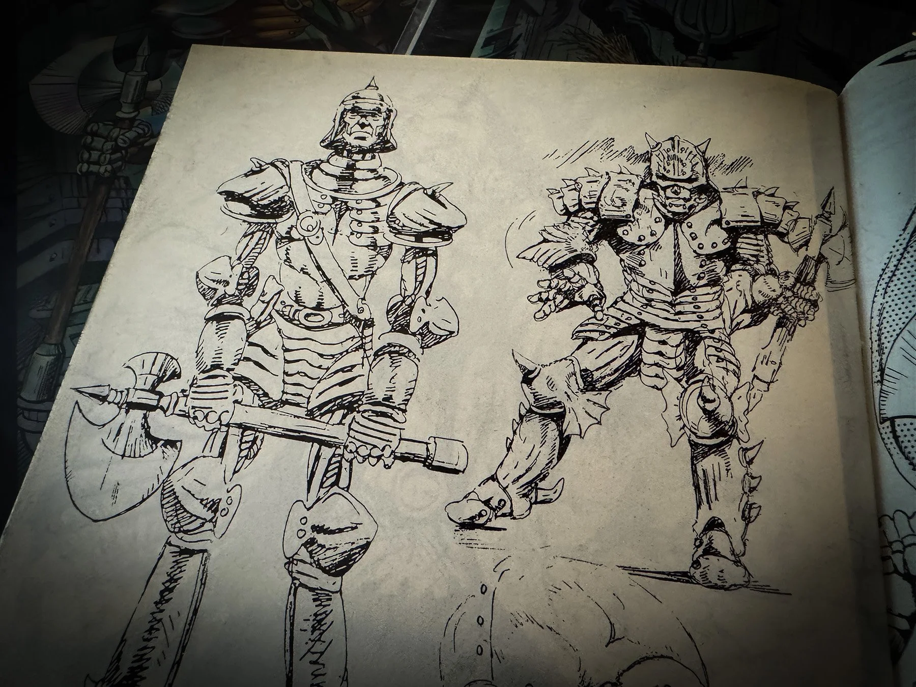Black-and-white concept sketches from Oz #1 by Caliber Comics showing early character designs for the Tin Woodman carrying a double-headed axe alongside an armored Nome soldier. The pen-and-ink artwork appears on an interior page of the comi