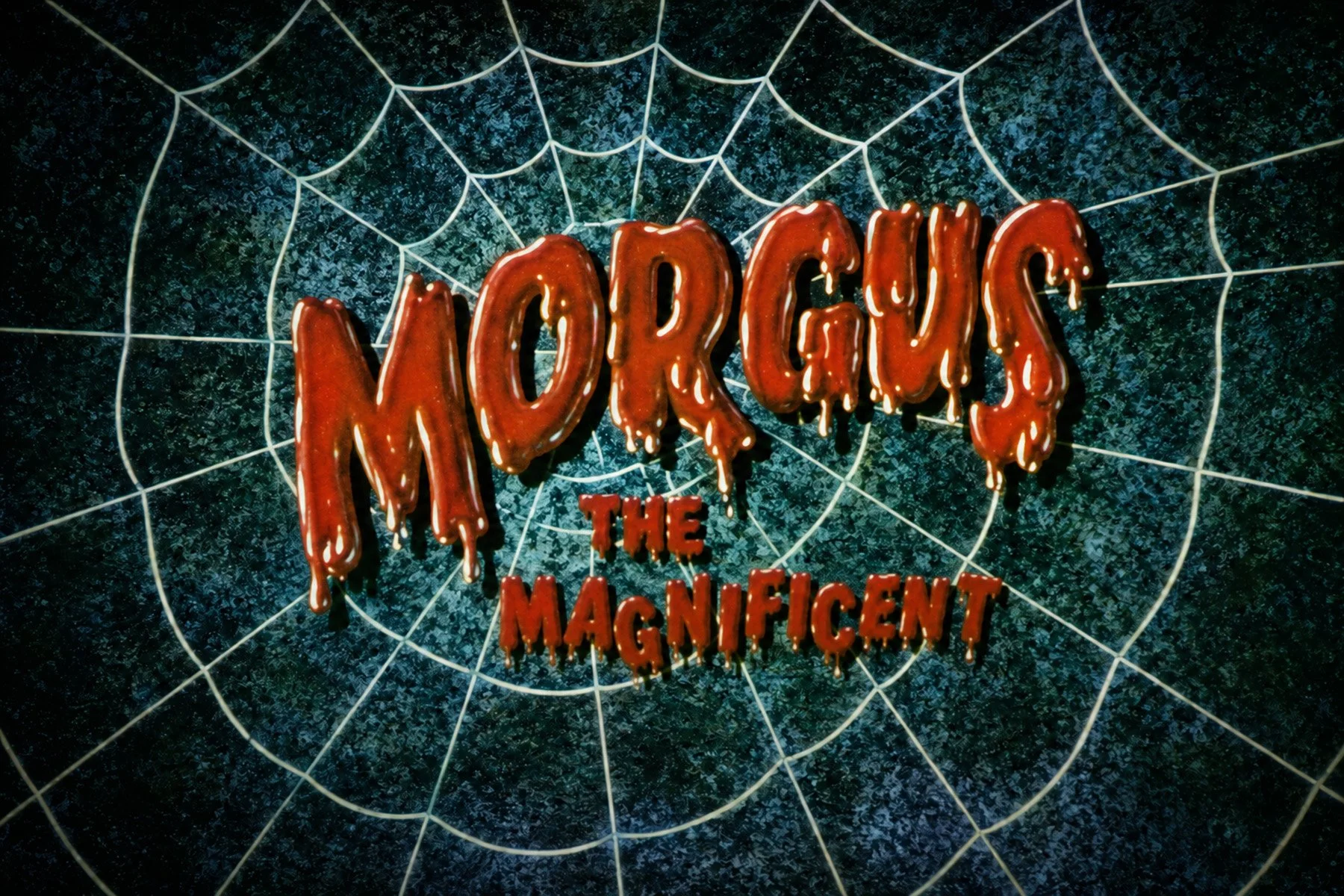 Restored Morgus the Magnificent title card with dripping red letters centered over a white spiderweb.