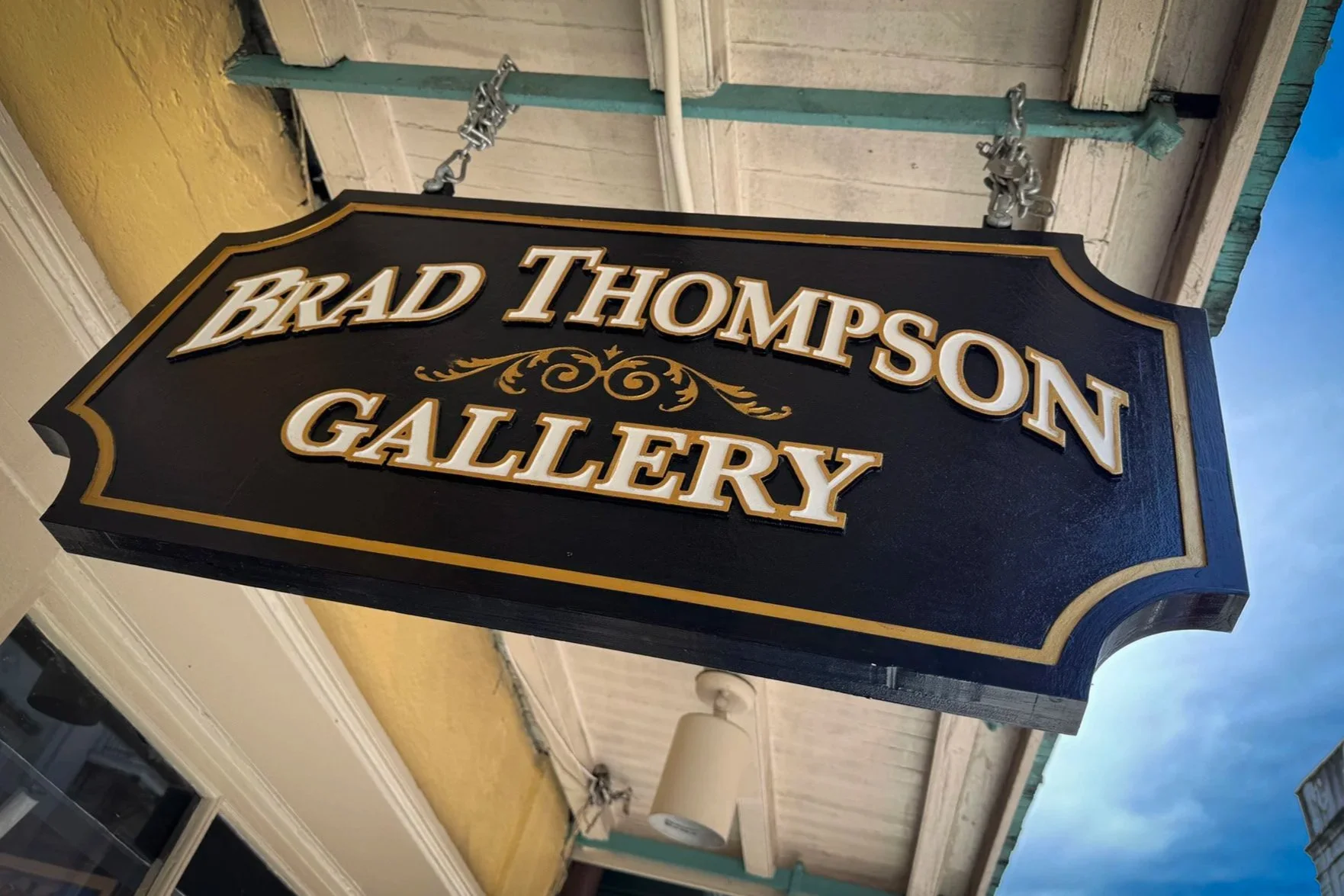 Brad Thompson Gallery sign hanging outside the artist’s gallery on Royal Street in the French Quarter.