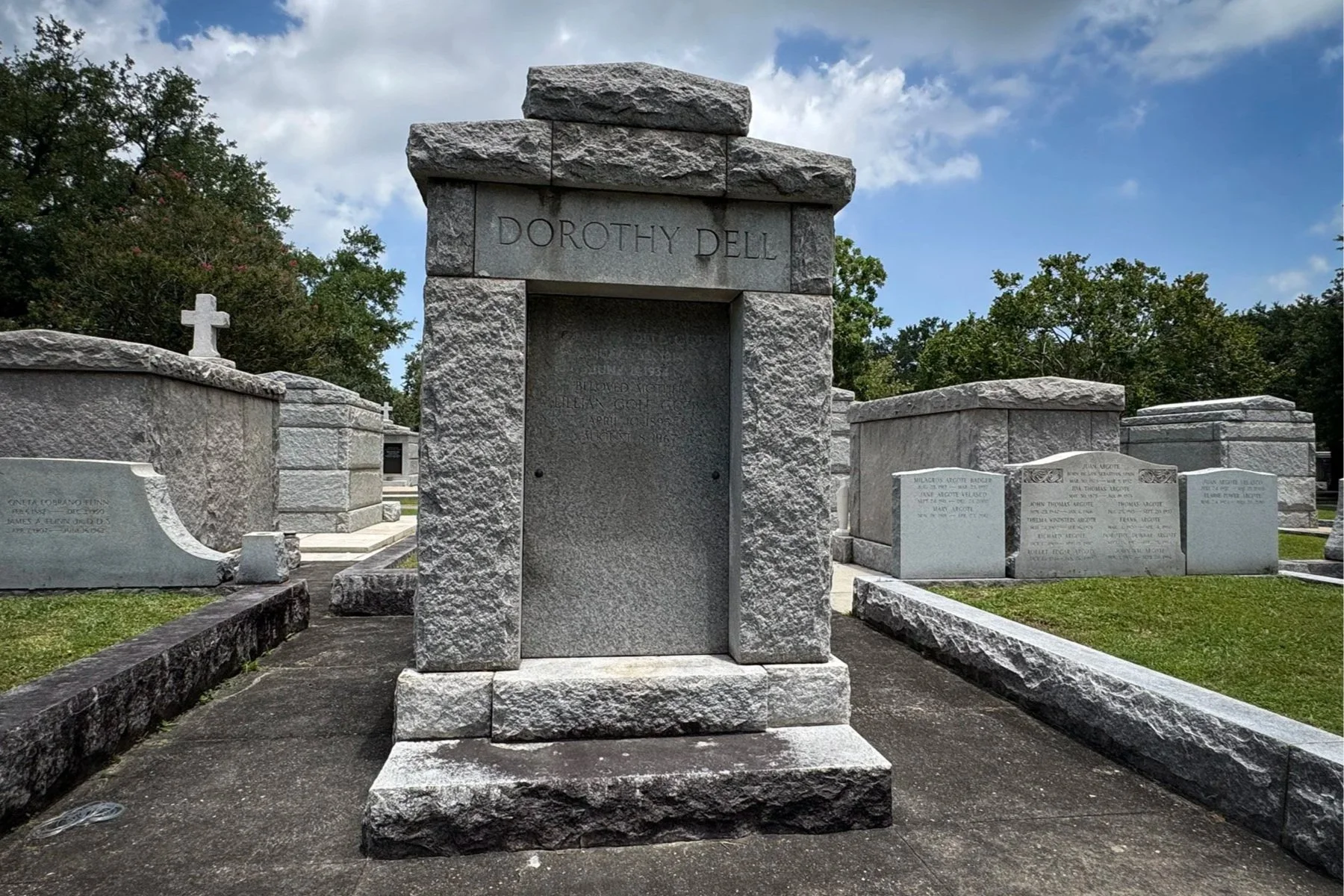 Granite tomb engraved with the name Dorothy Dell in Metairie Cemetery.