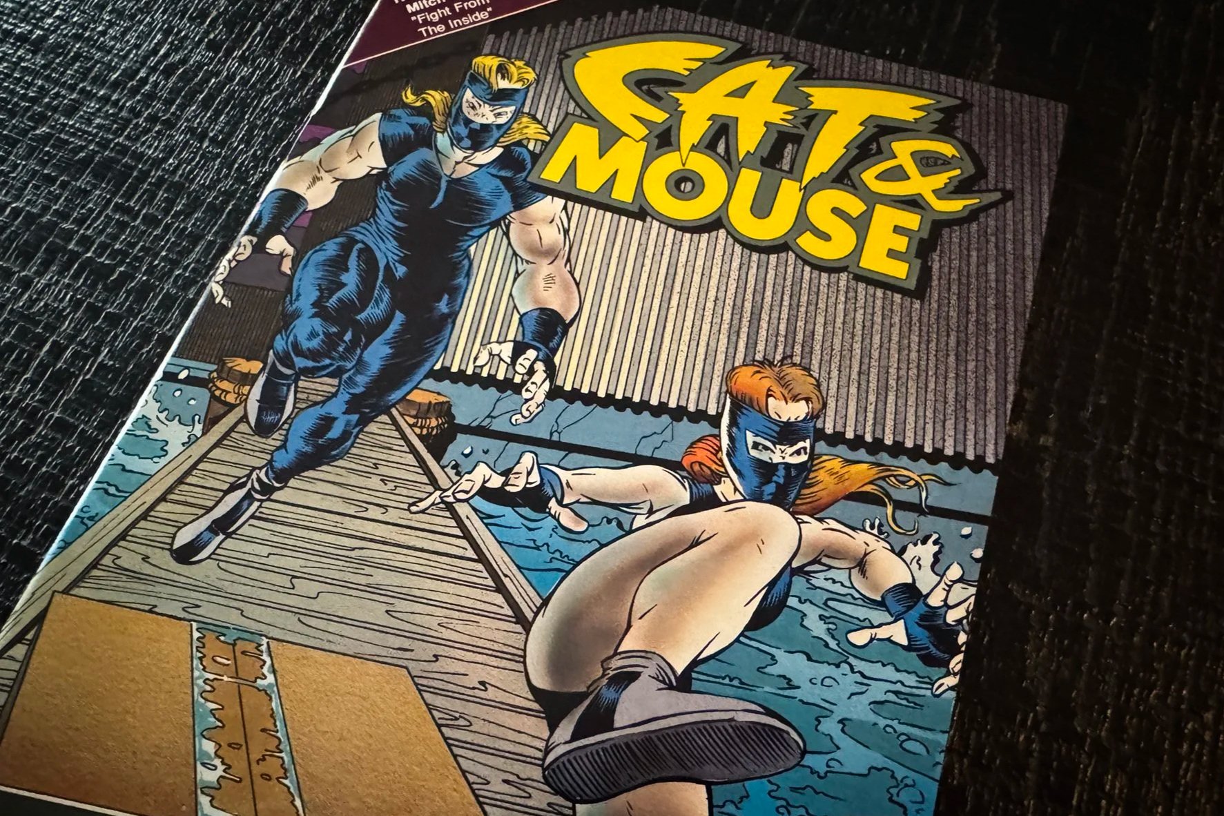 Mitch Byrd’s cover for Cat & Mouse No. 8 showing the masked Cat and Mouse leaping across a New Orleans dock.