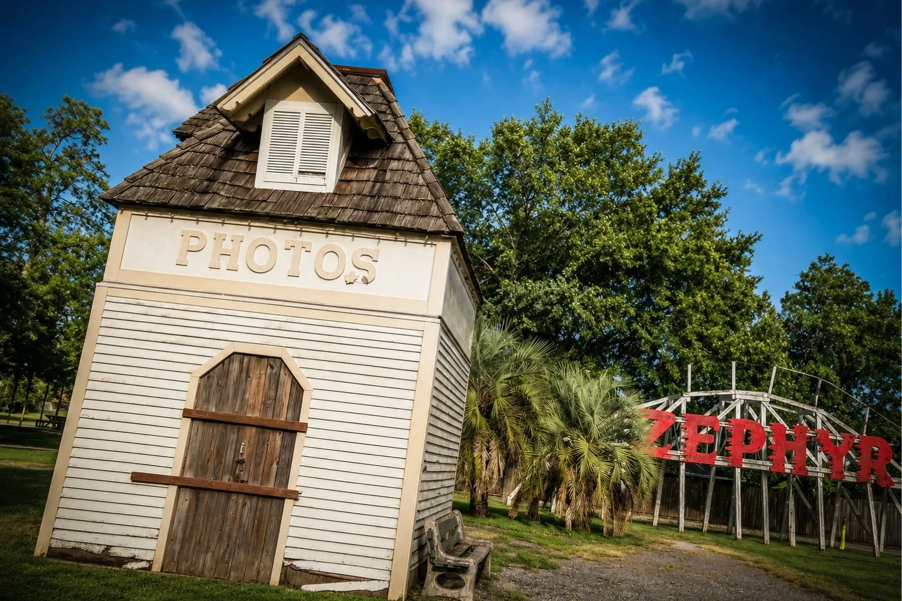 Former Pontchartrain Beach photo booth and the preserved Zephyr roller coaster crest displayed together in Rivertown Historic District in Kenner, Louisiana.