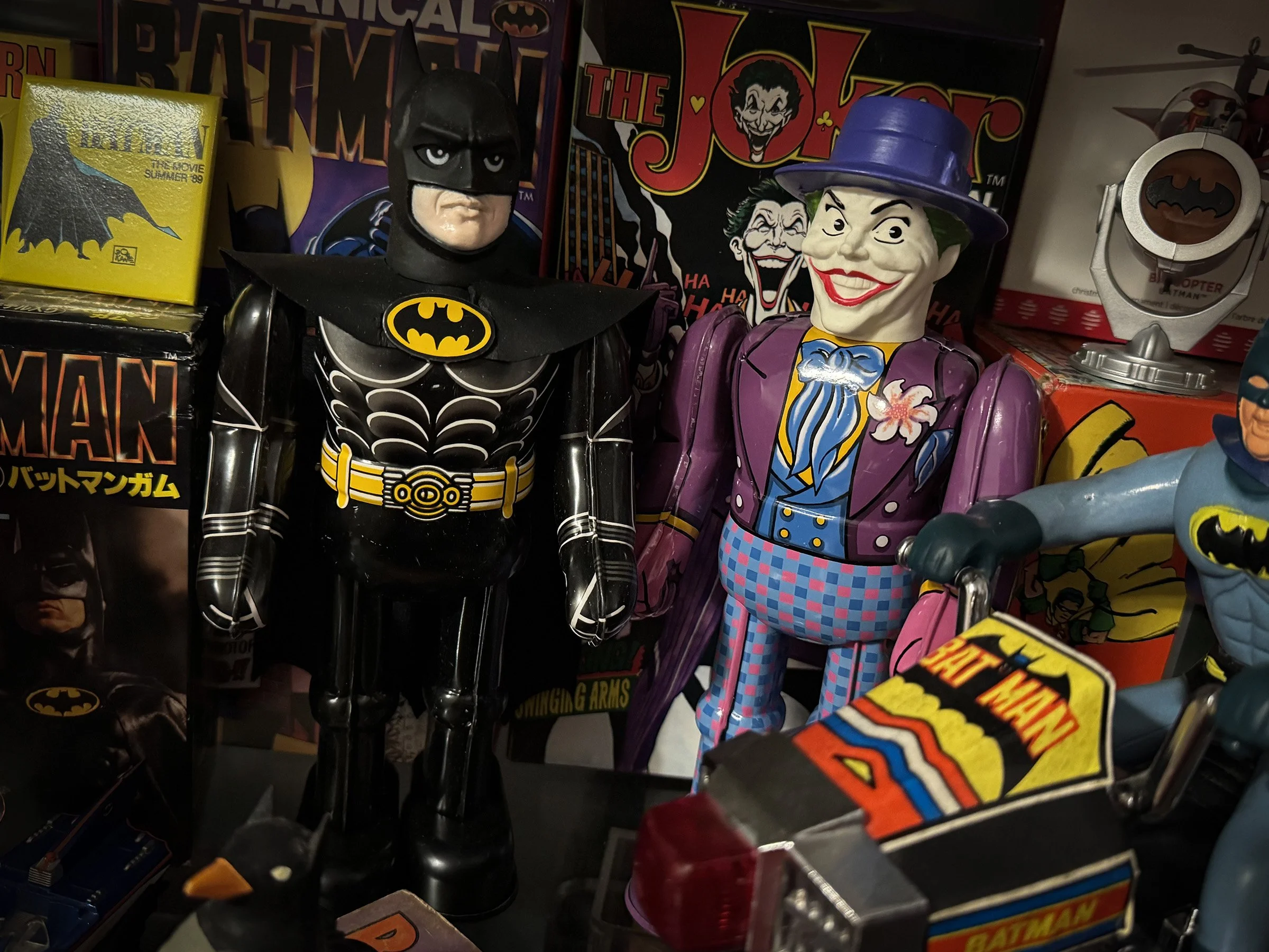 Japanese Billiken Shokai Batman and Joker wind-up tin toys displayed among Batman (1989) collectibles and movie memorabilia.