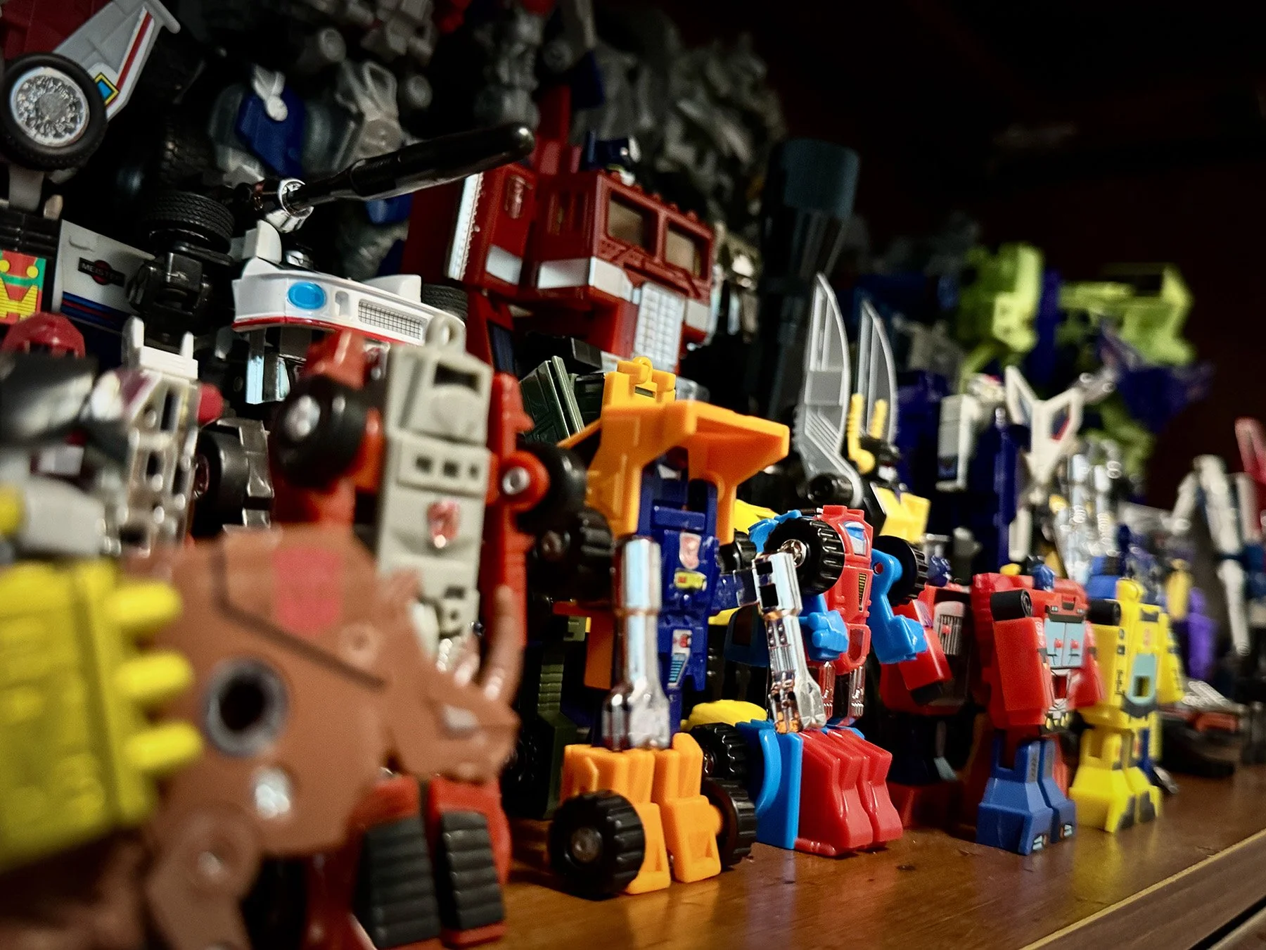 Vintage G1 Transformers figures displayed together on a shelf in Marco's collection room.