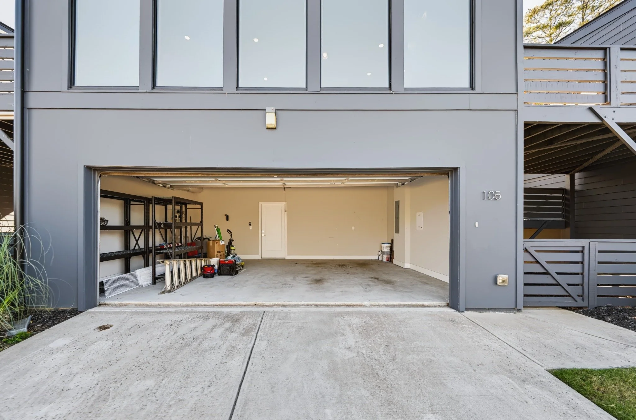 Original garage photograph with shelving, tools, and stored belongings