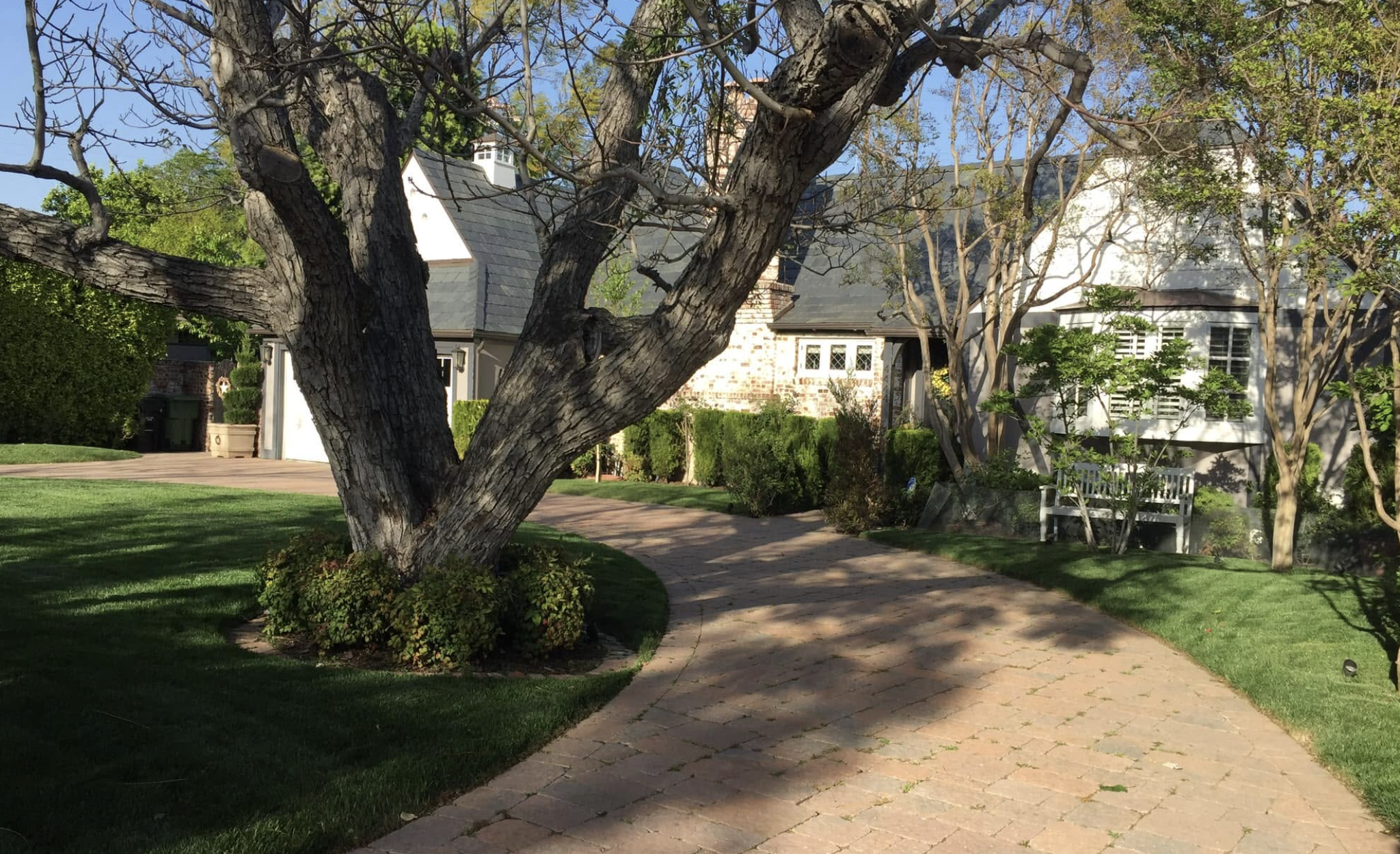 A flat, tree-lined residential street of character homes in Colfax Meadows, Studio City