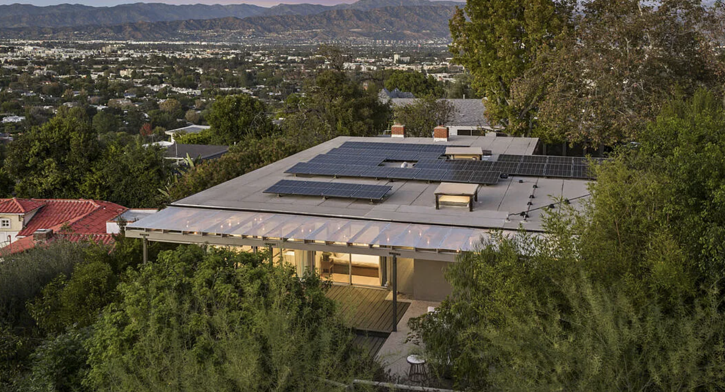 The glass-walled living room and exposed beams of the 1962 Chapman and McCorkell post-and-beam house at 11526 Laurelcrest Drive in Studio City.