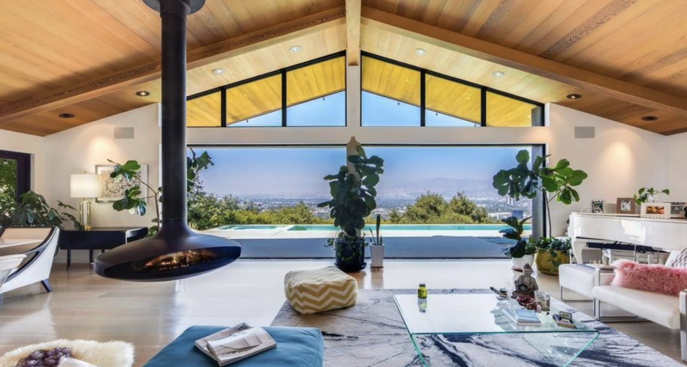 A mid-century modern home with walls of glass on a winding hillside street in Wrightwood Estates, Studio City, with canyon views