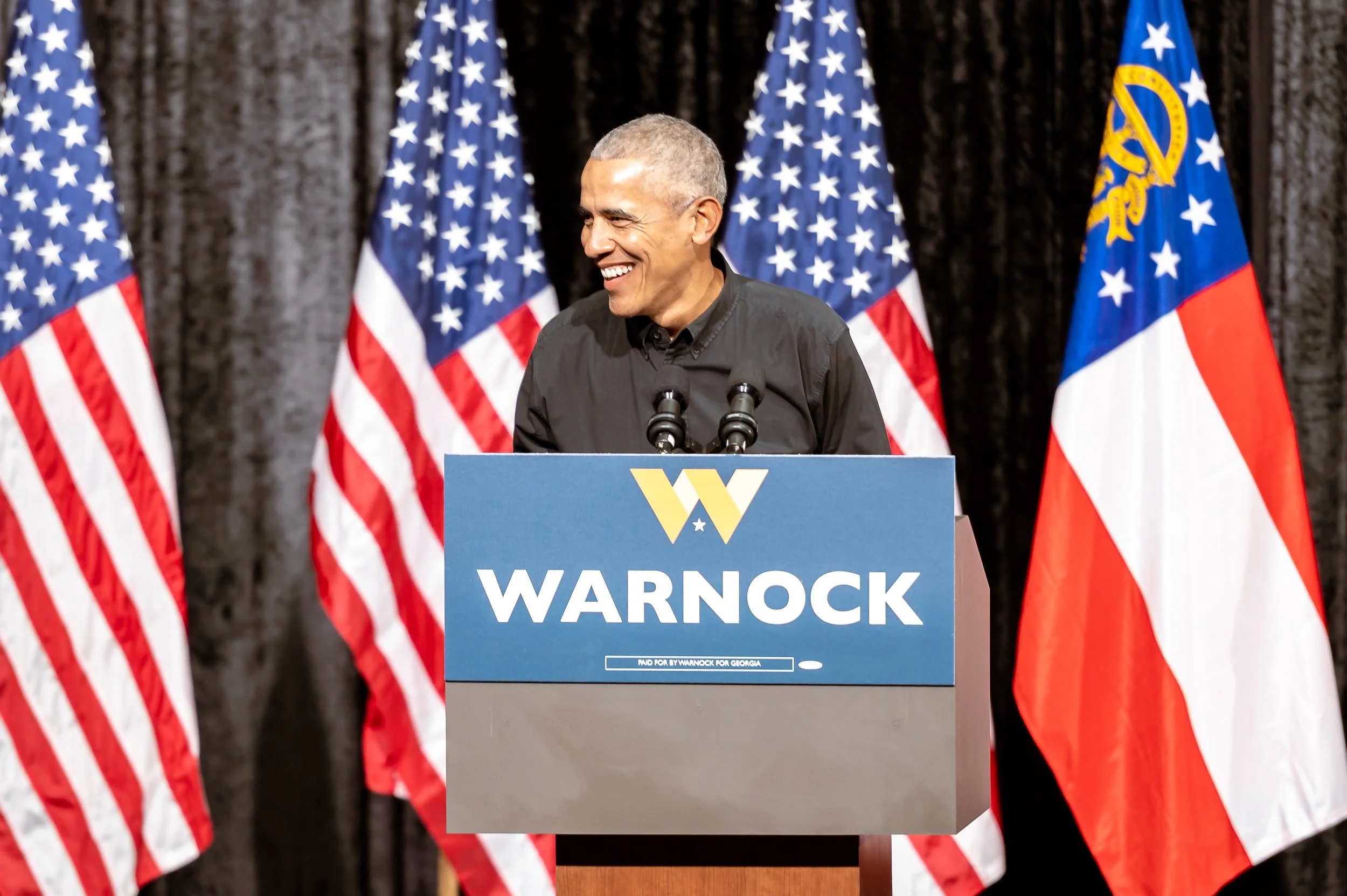 Former President Barack Obama speaking at Senator Raphael Warnock's campaign rally in Atlanta, Georgia.
