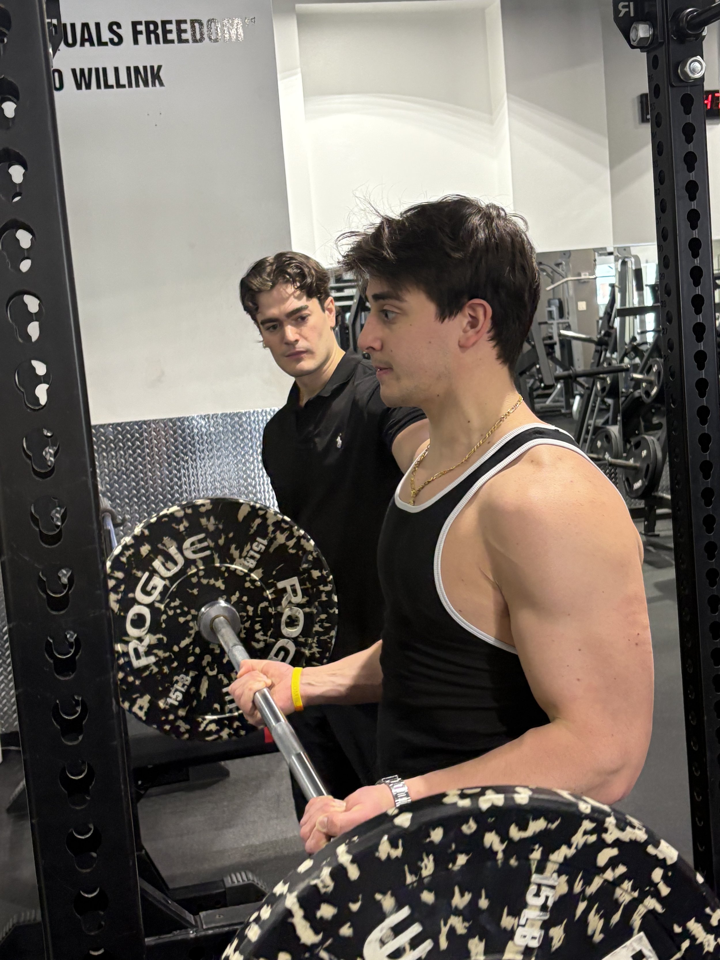 Billy Vetter coaches a client during a barbell strength-training session.