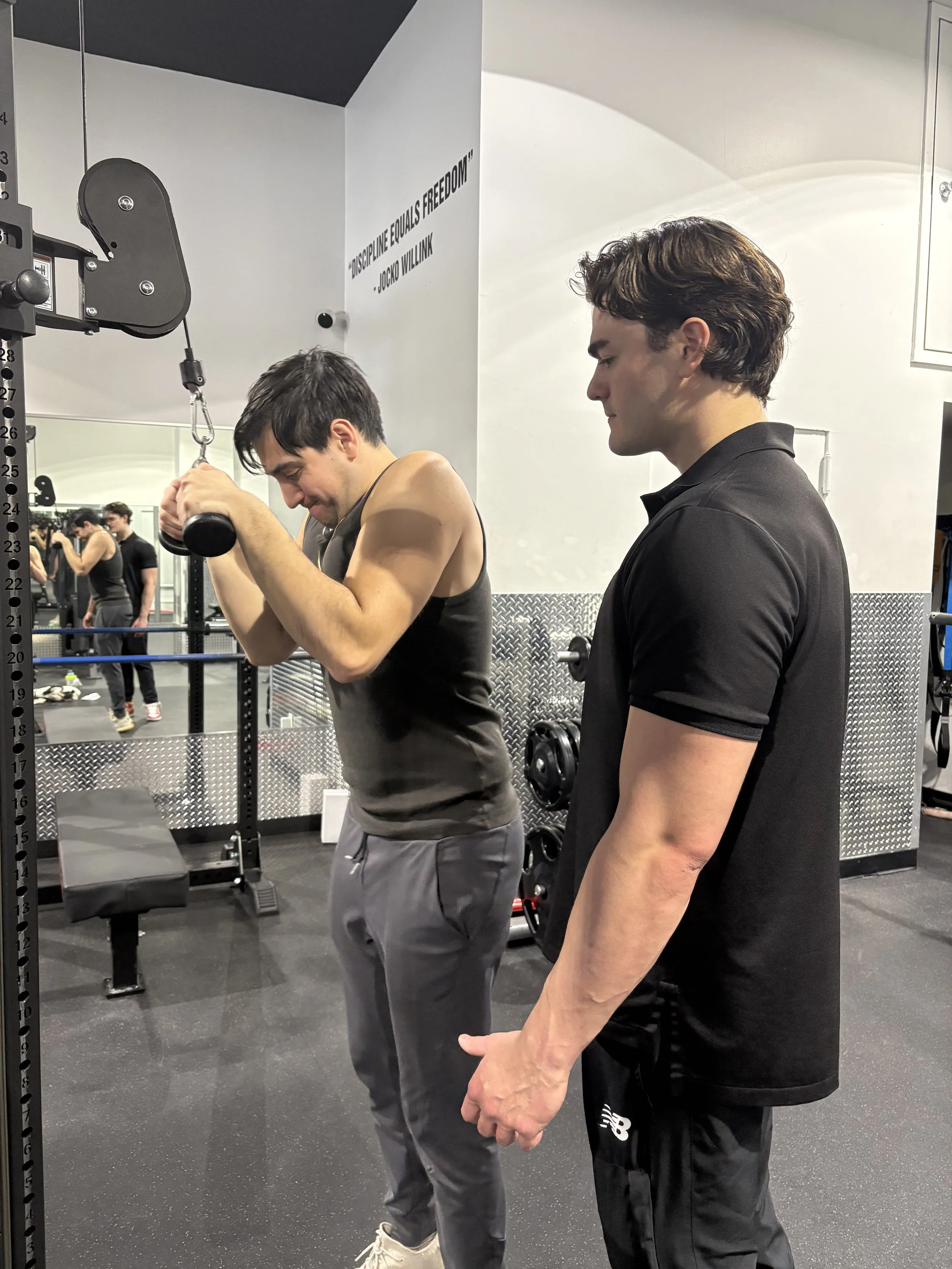 Billy Vetter coaches a client during a dumbbell strength-training session.