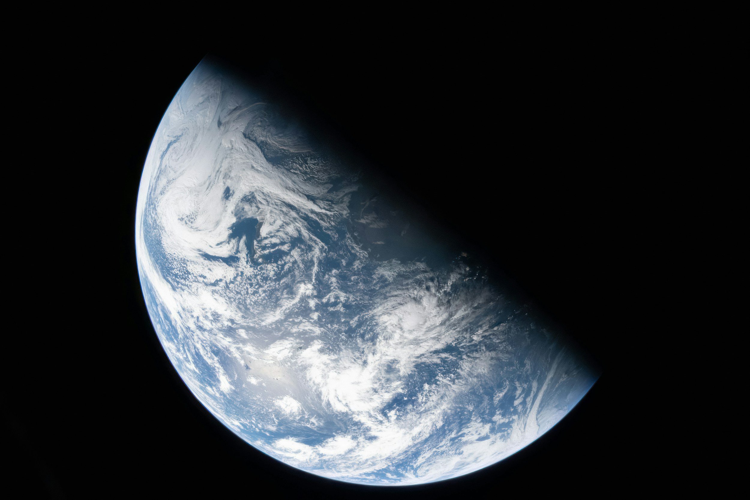 Earth seen from space with a black backdrop.