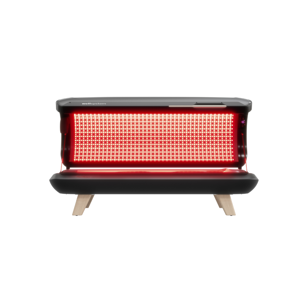 WellSystem RedWave Pure Red light therapy bed. . Red infrared therapy device with a large LED panel, black casing, and wooden legs on a white background.
