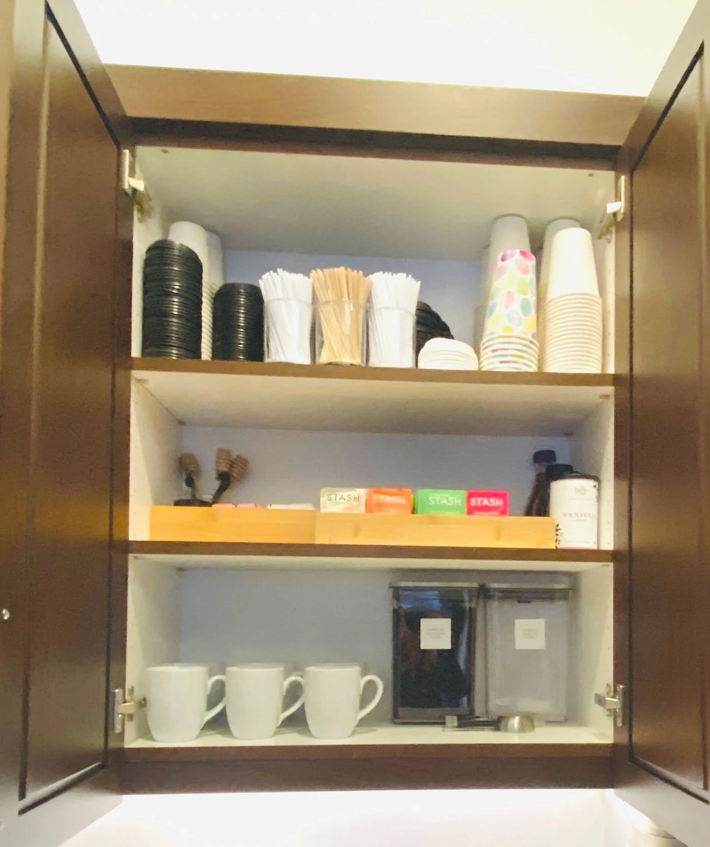 Premium home coffee station and cabinet organization featuring neatly arranged coffee beans, teas, mugs, and brewing supplies in Park City, Utah.