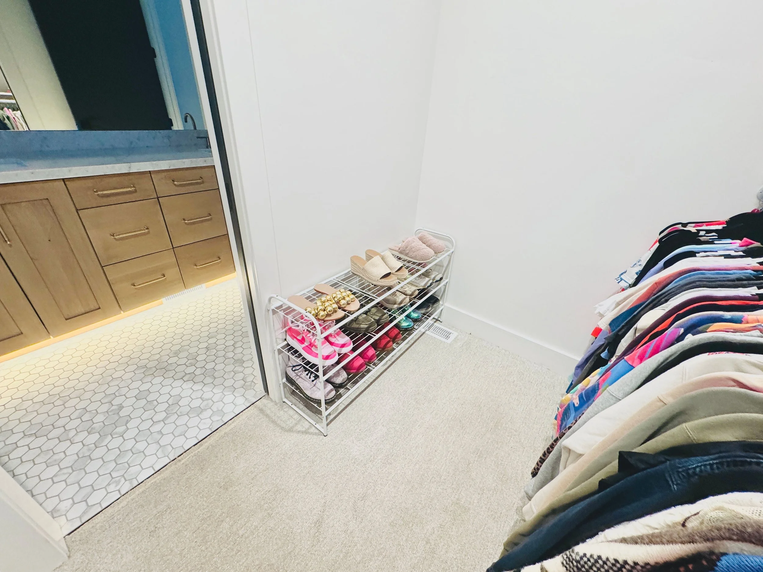 Walk-in closet shoe organization featuring custom shelving and a perfectly sorted display of footwear in a Park City, Utah residence.