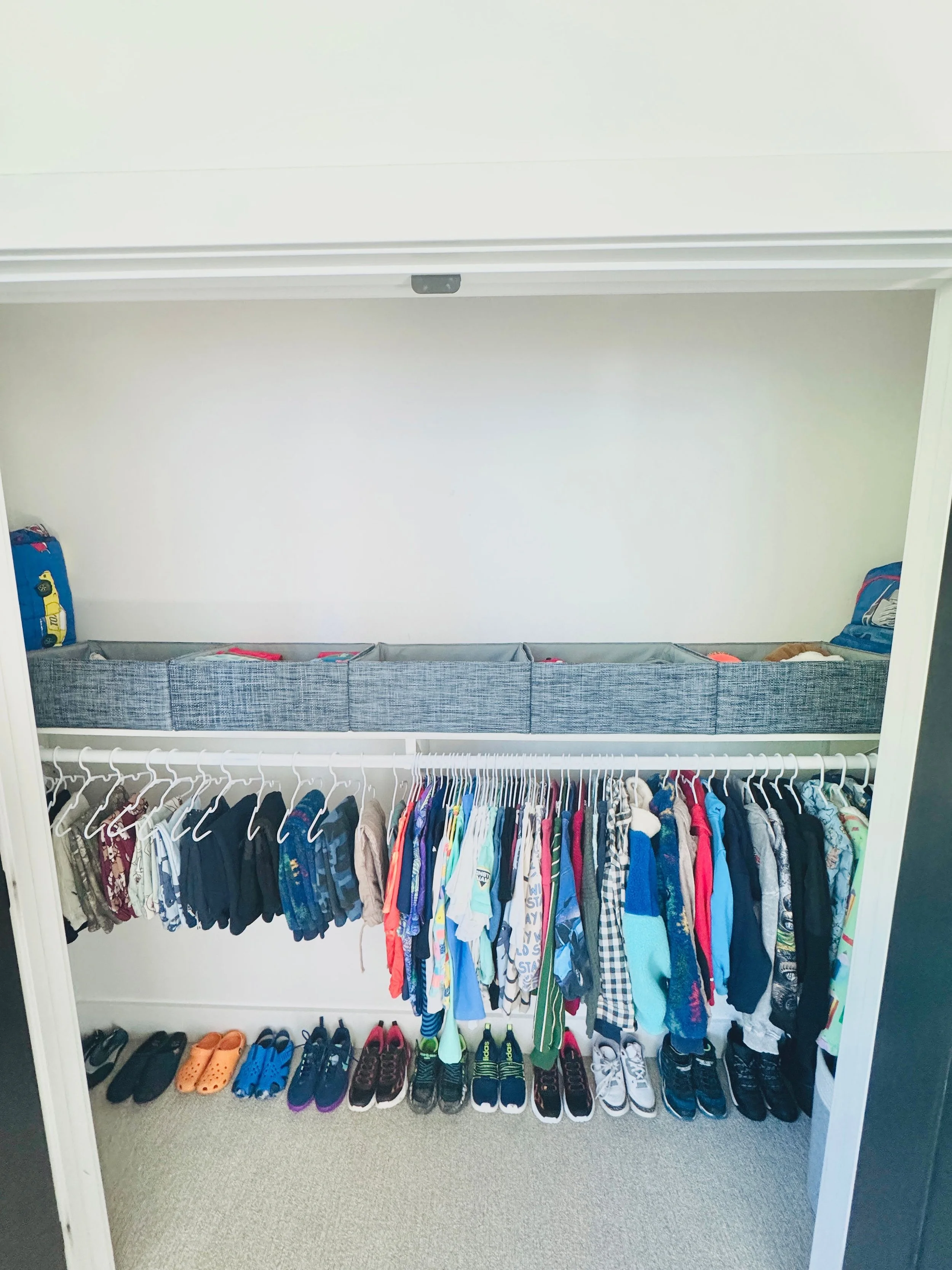Organized boys' bedroom closet featuring categorized clothing storage in Park City, Utah.