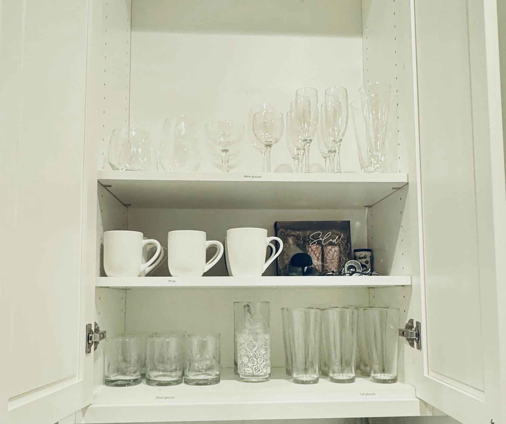 Multi-functional kitchen beverage cabinet organization displaying sorted wine glasses, shot glasses, everyday cups, and coffee essentials in Park City, Utah.