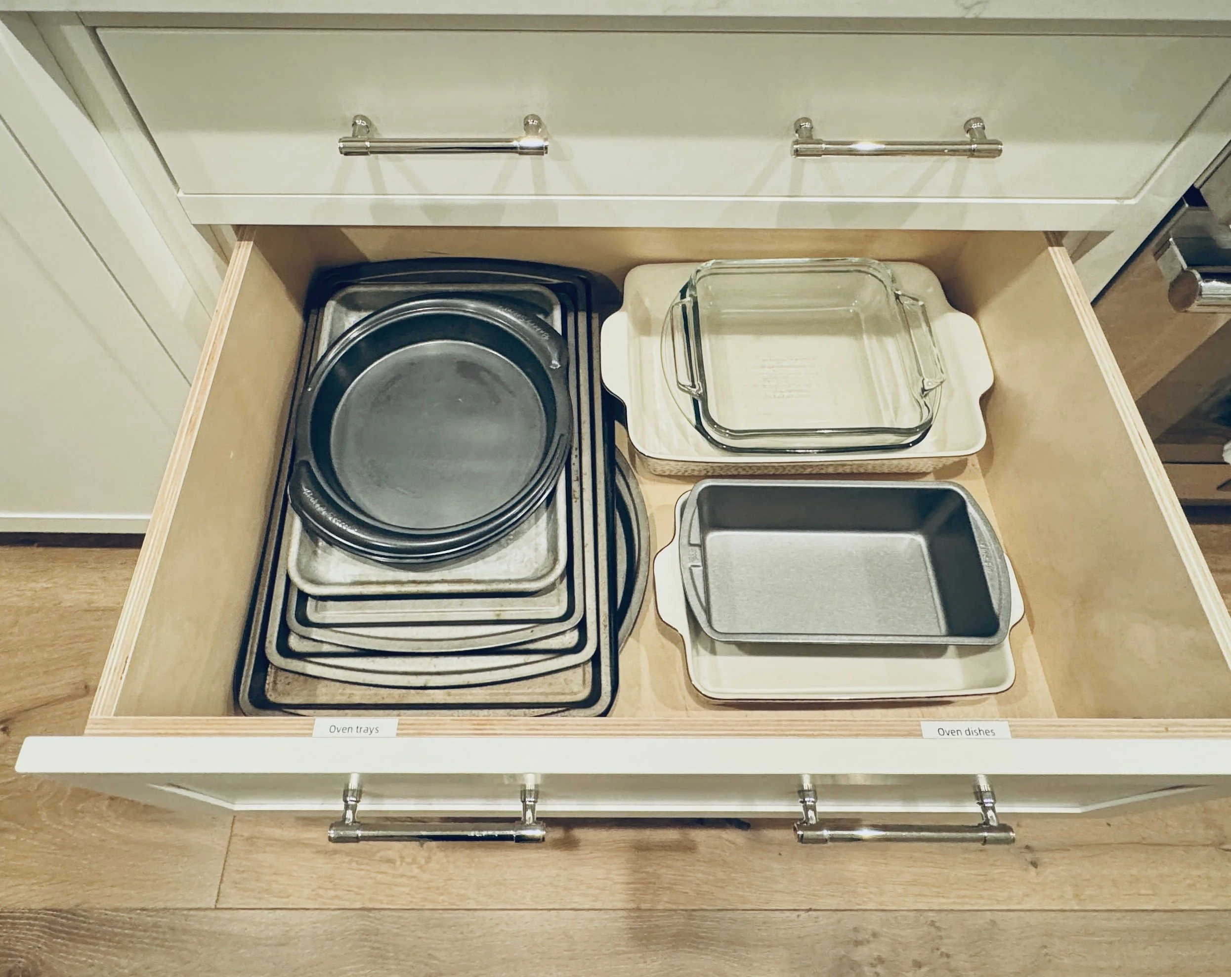 Efficient kitchen cabinet organization featuring a drawer for baking pans, cookie sheets, and oven trays in Park City, Utah.