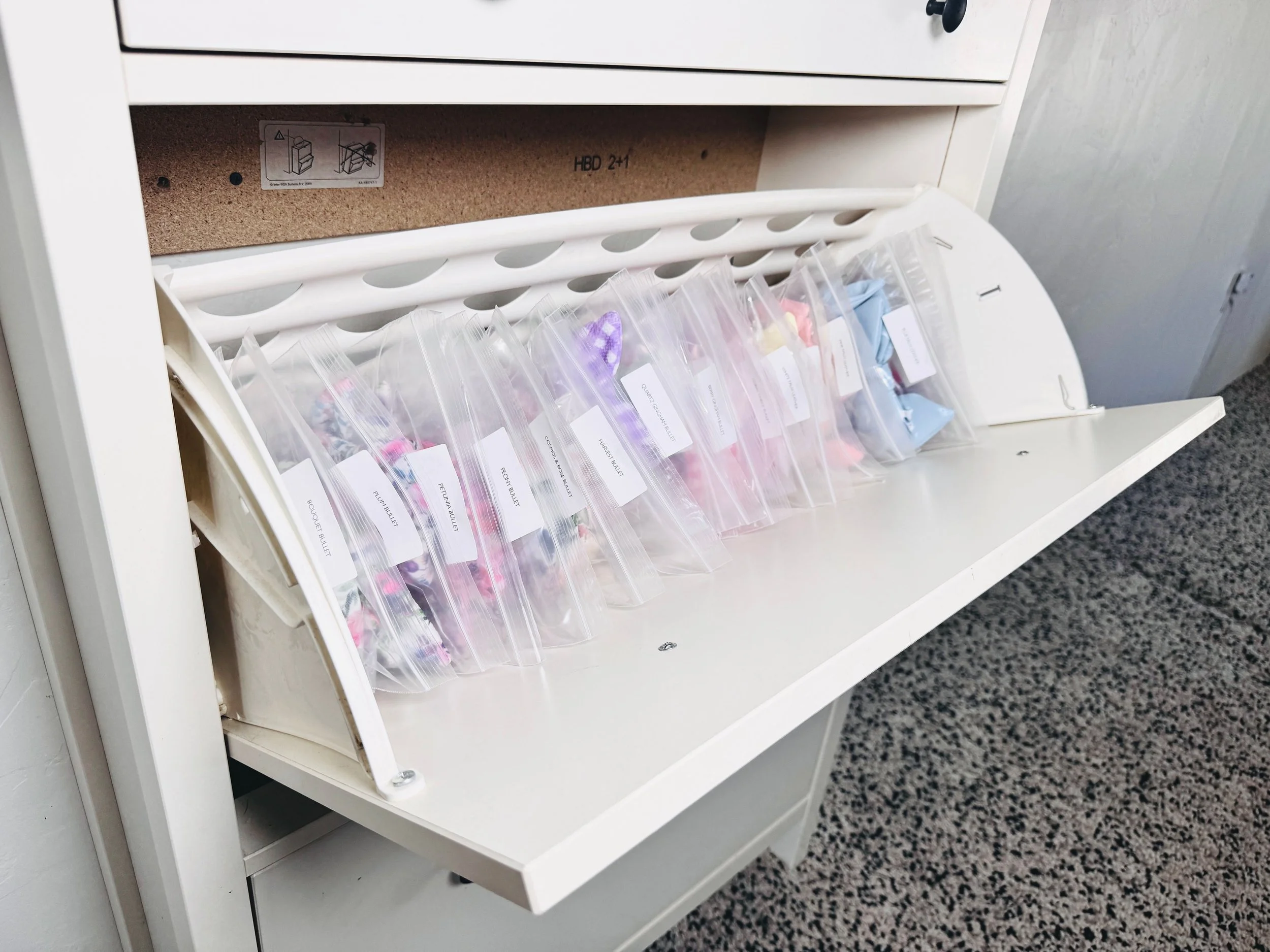 Organized inventory management system for an Etsy shop featuring sorted products stored in clearly labeled protective bags in Park City, Utah.