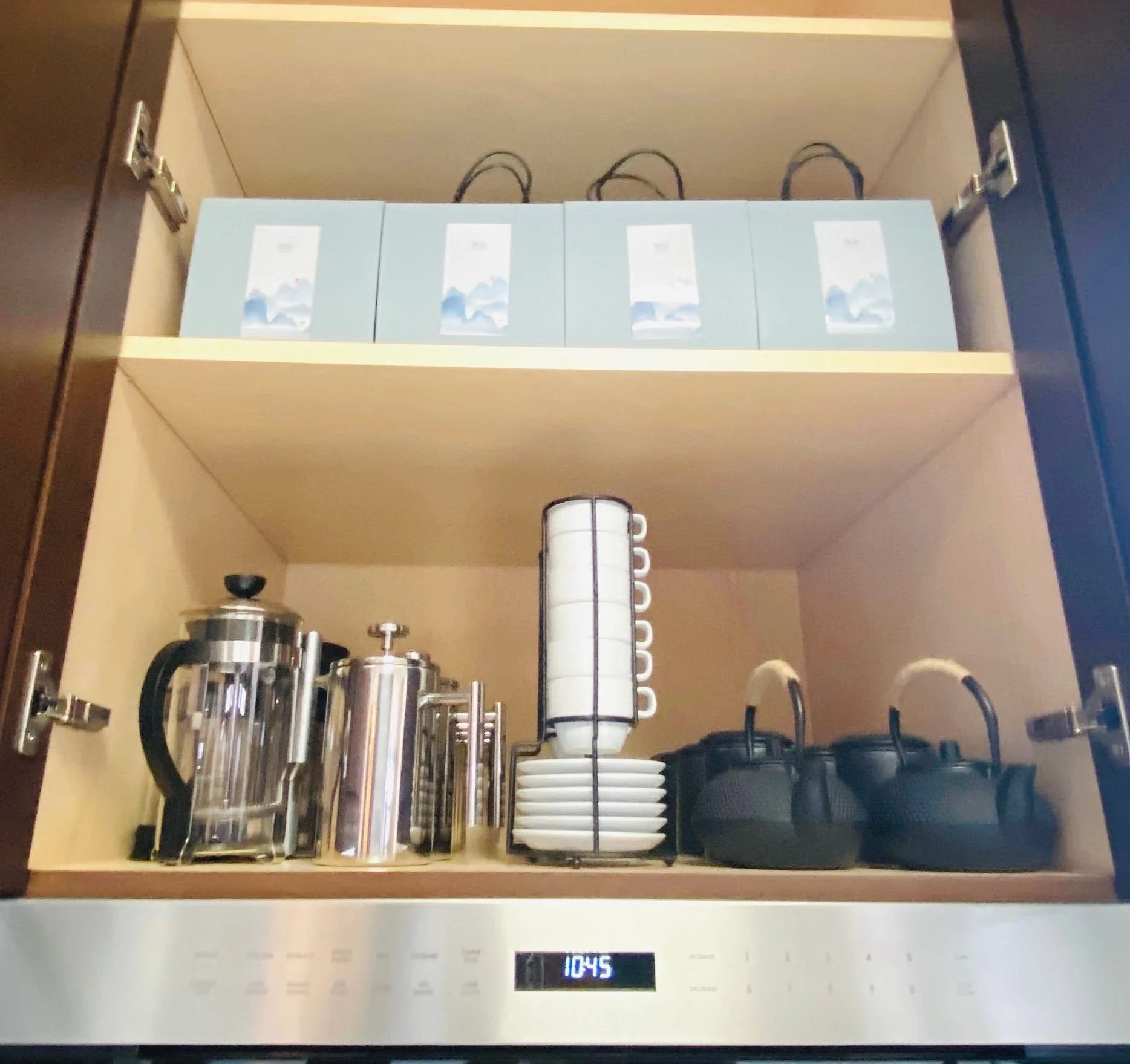 Kitchen cabinet organization featuring neatly arranged tea selections, mugs, and kettle storage in Park City, Utah.