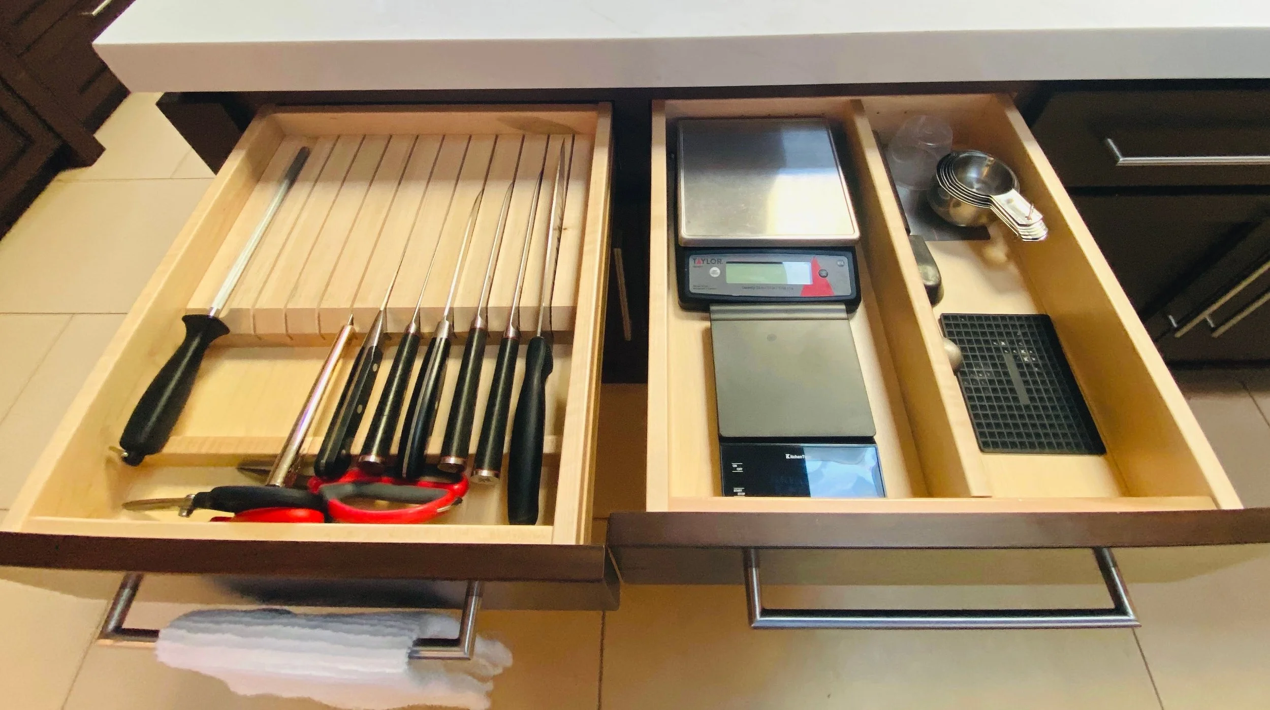 Functional kitchen drawer organization featuring designated spots for chef knives, digital food scales, and nested measuring cups in Park City, Utah.