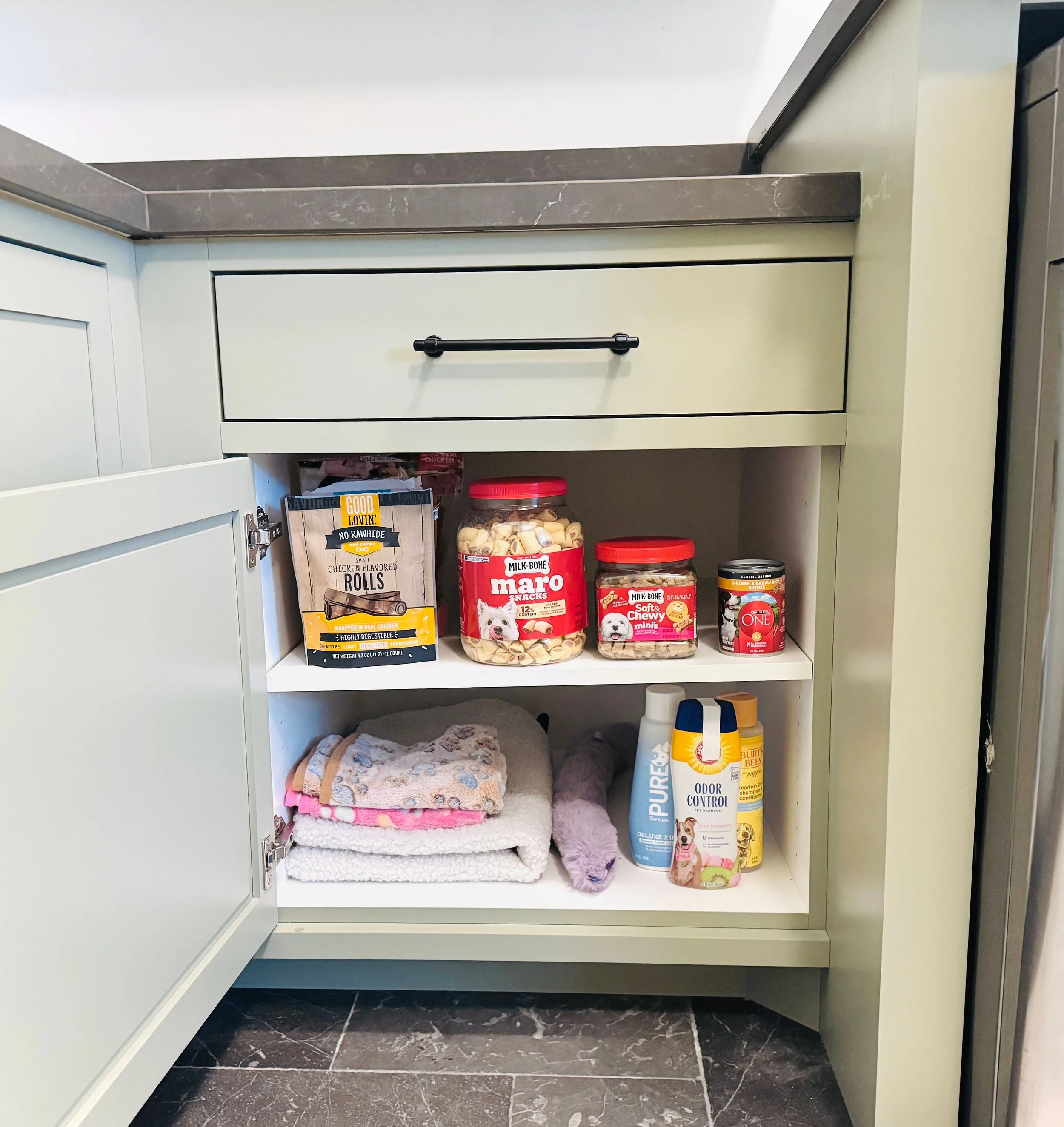 Dedicated pet supply zone and dog gear organization in a Park City mudroom.